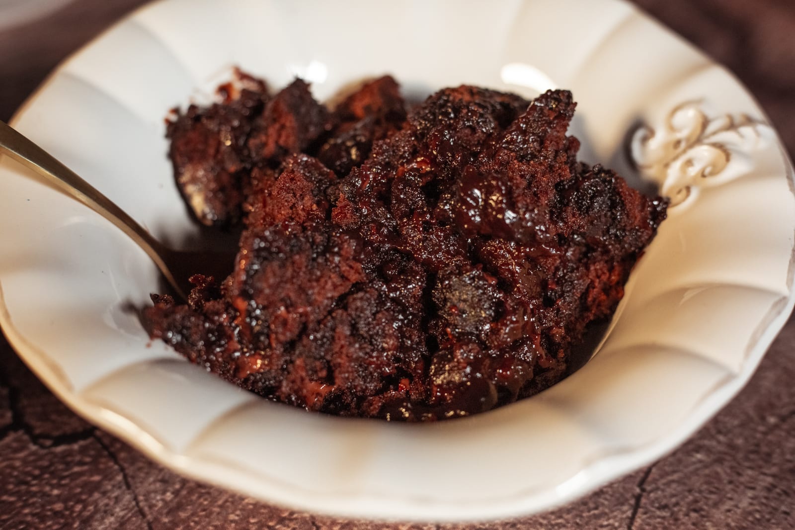 A serving of chocolate pudding in its glossy sauce