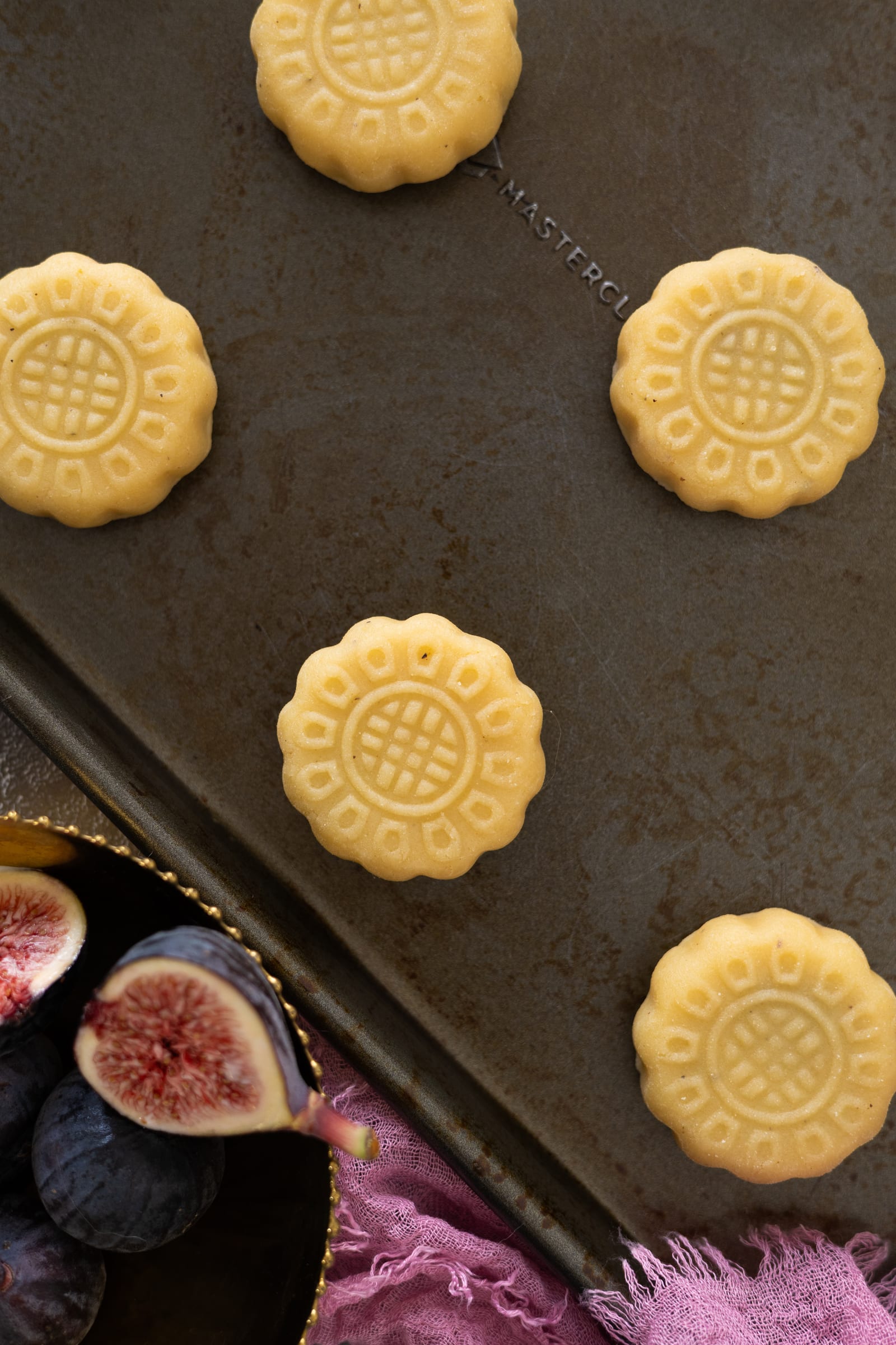 Moulded ma'amoul on a baking tray before baking