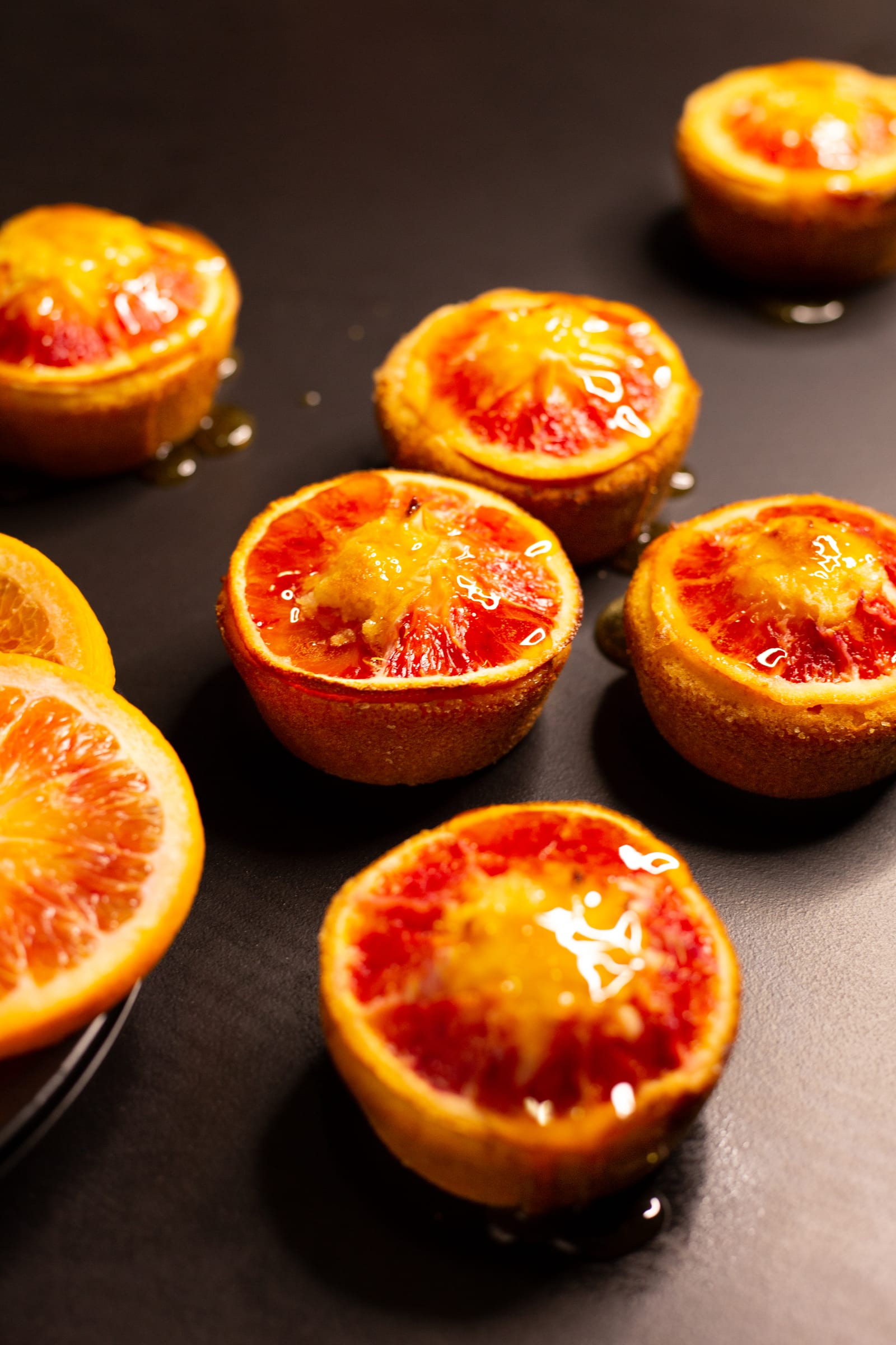 Almond, semolina and blood orange syrup cakes glazed with syrup before dusting