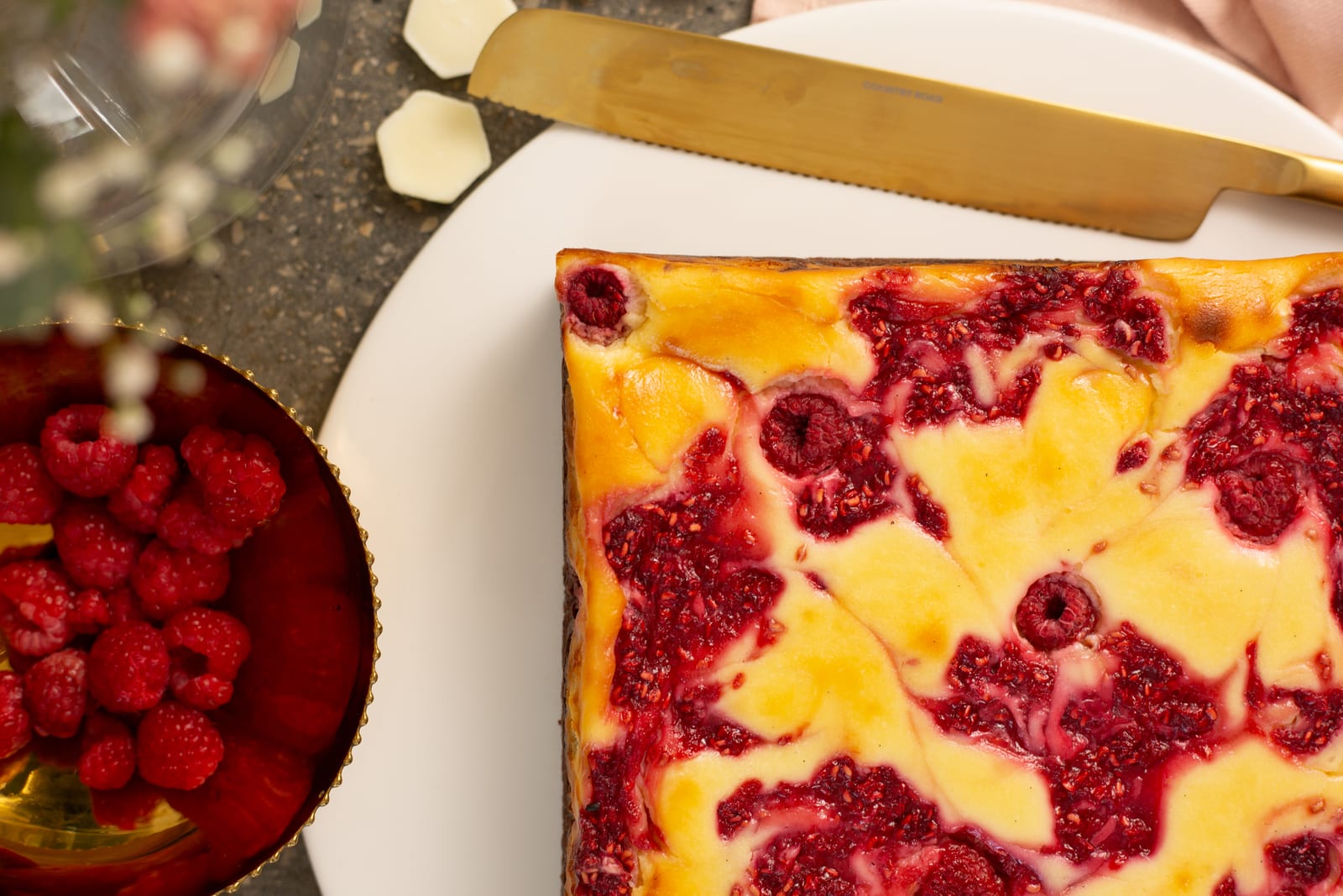 Close-up of the baked raspberry ripple, beside a bowl of raspberries