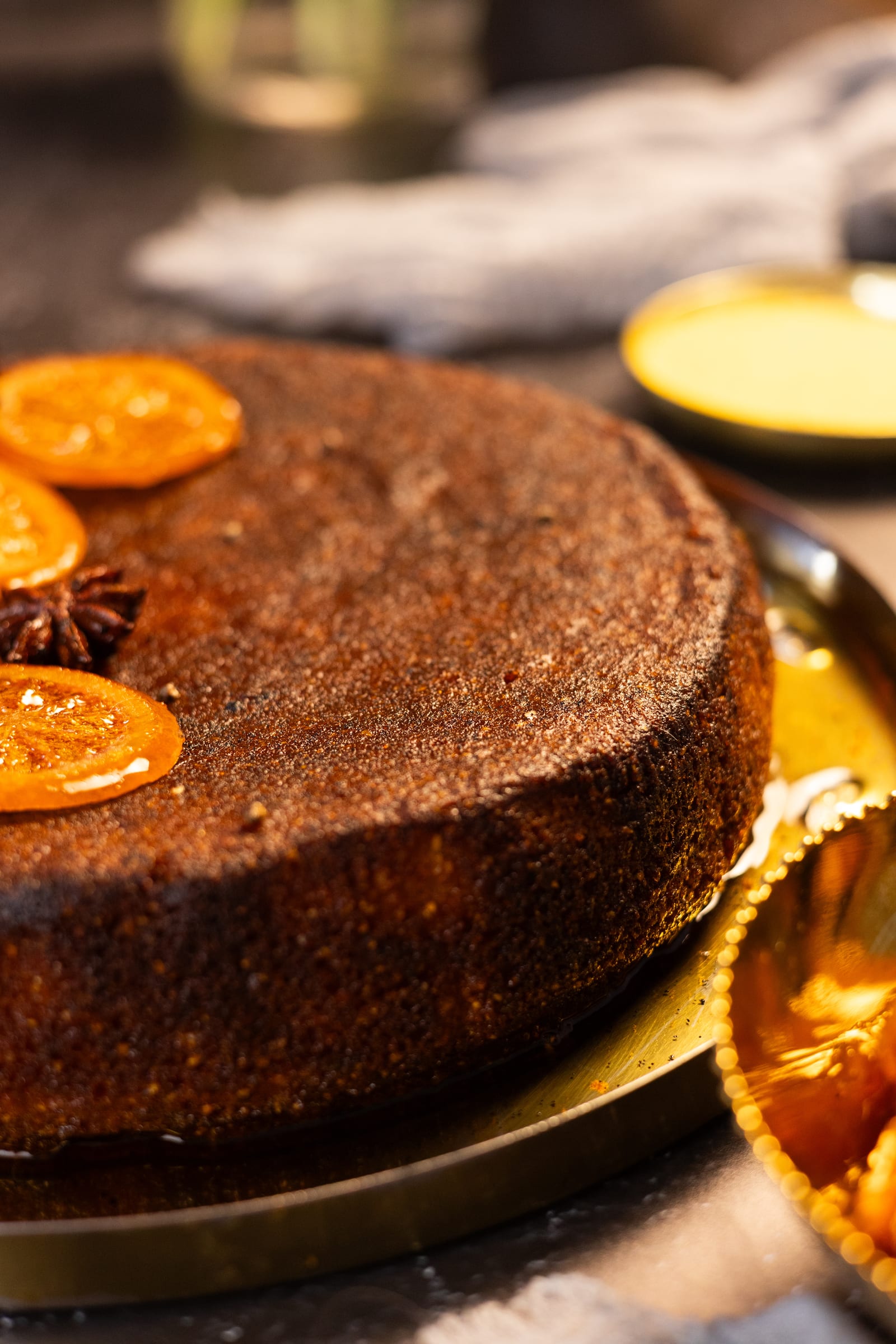 The side of the cake, with candied orange slices on top