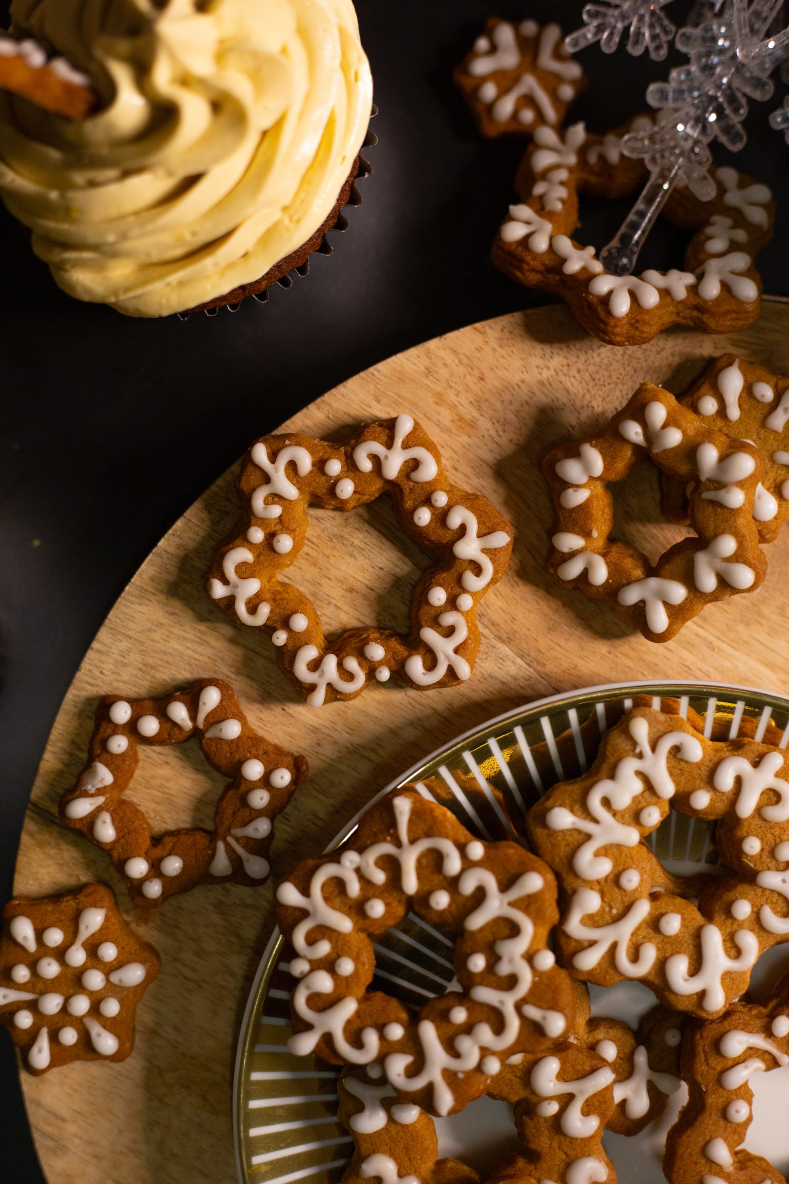 Iced pretzel stars scattered across wooden boards, from above