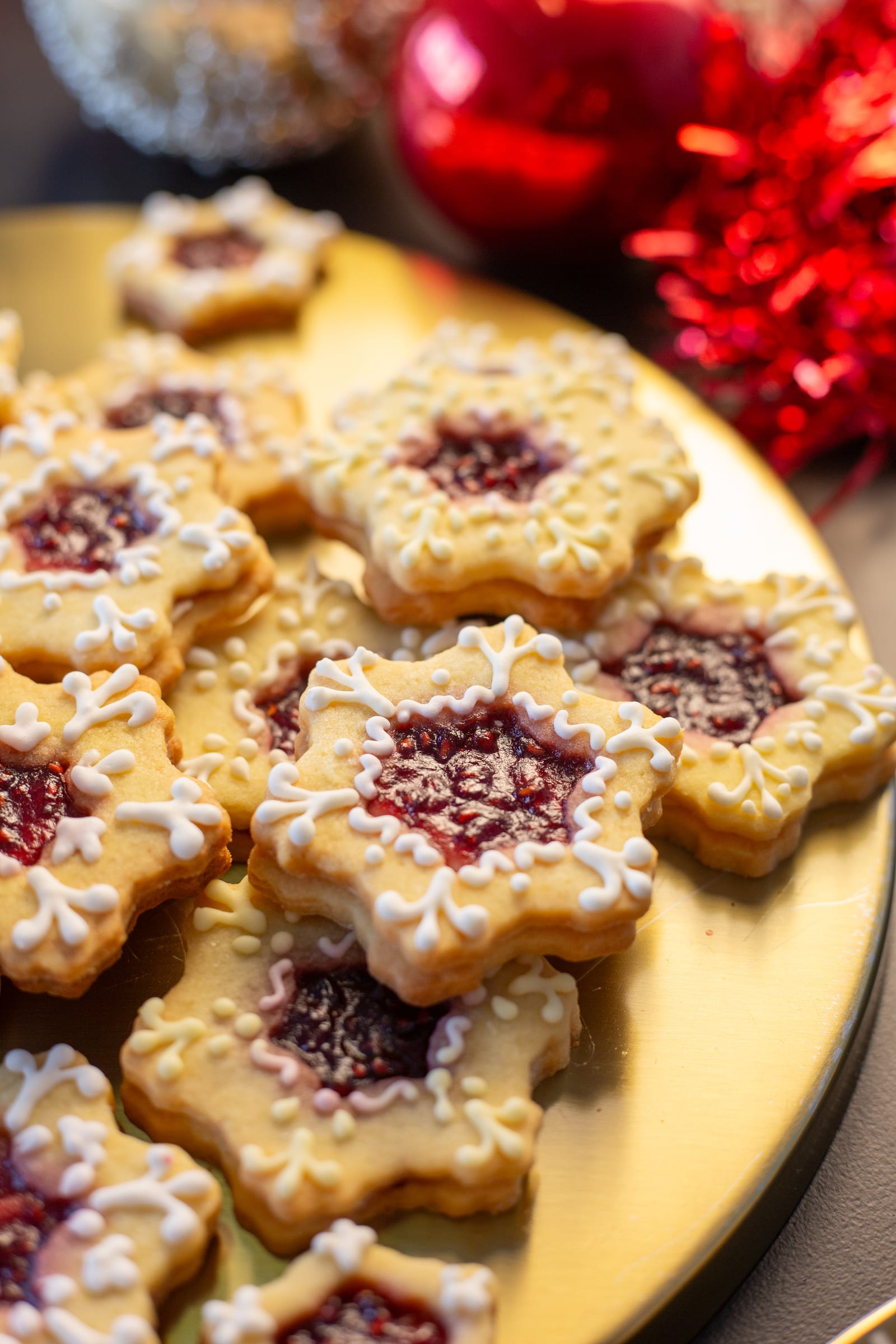 Close-up of star-shaped lemon and raspberry Linzer cookies with raspberry jam centres and iced edges