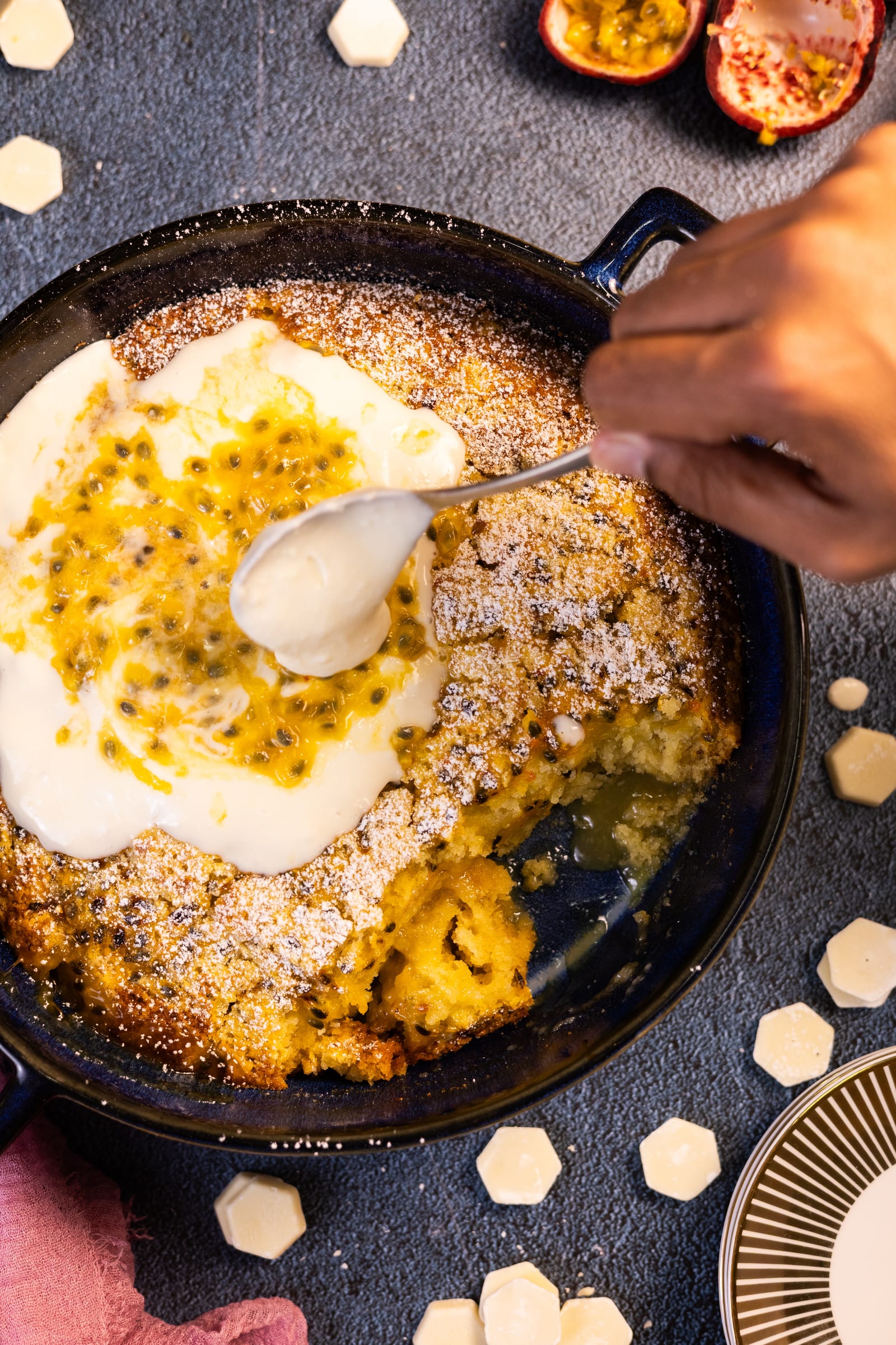 A spoon lifting coconut cream from the pudding