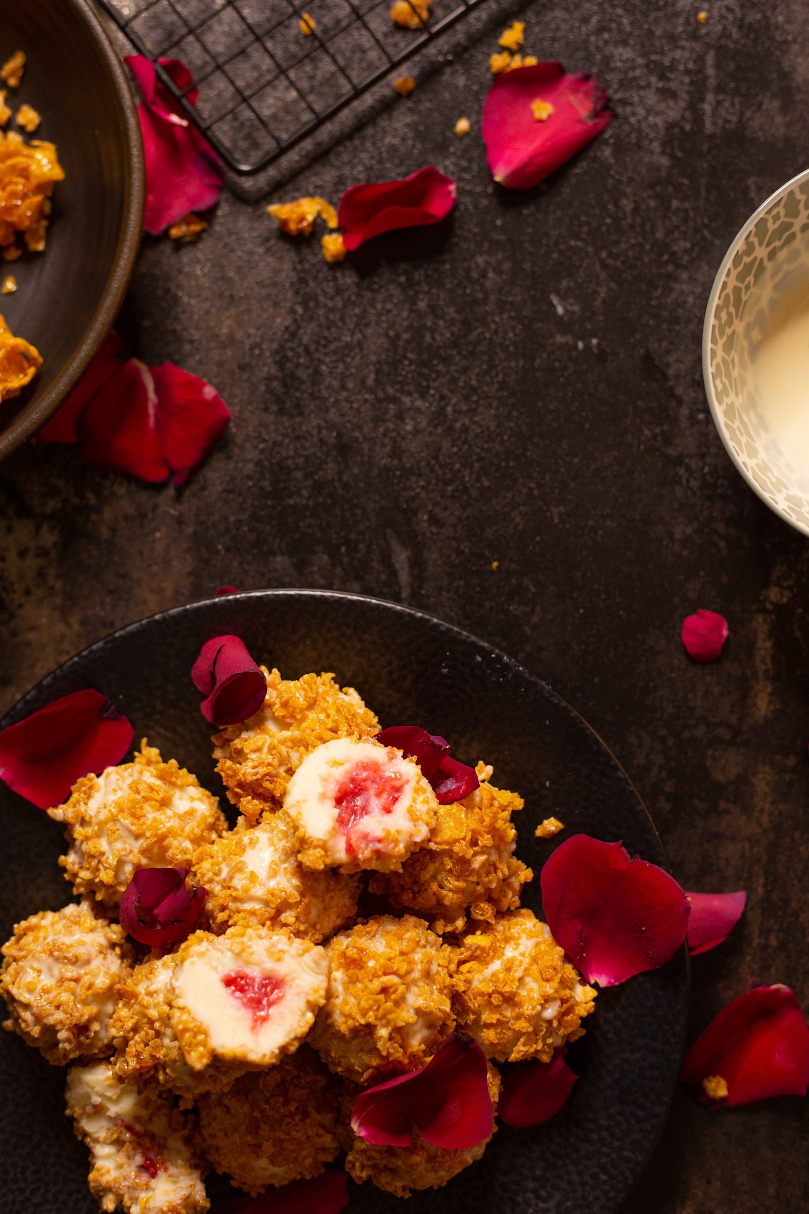 Raspberry and white chocolate truffles with cornflake crunch from above, halved to show the raspberry