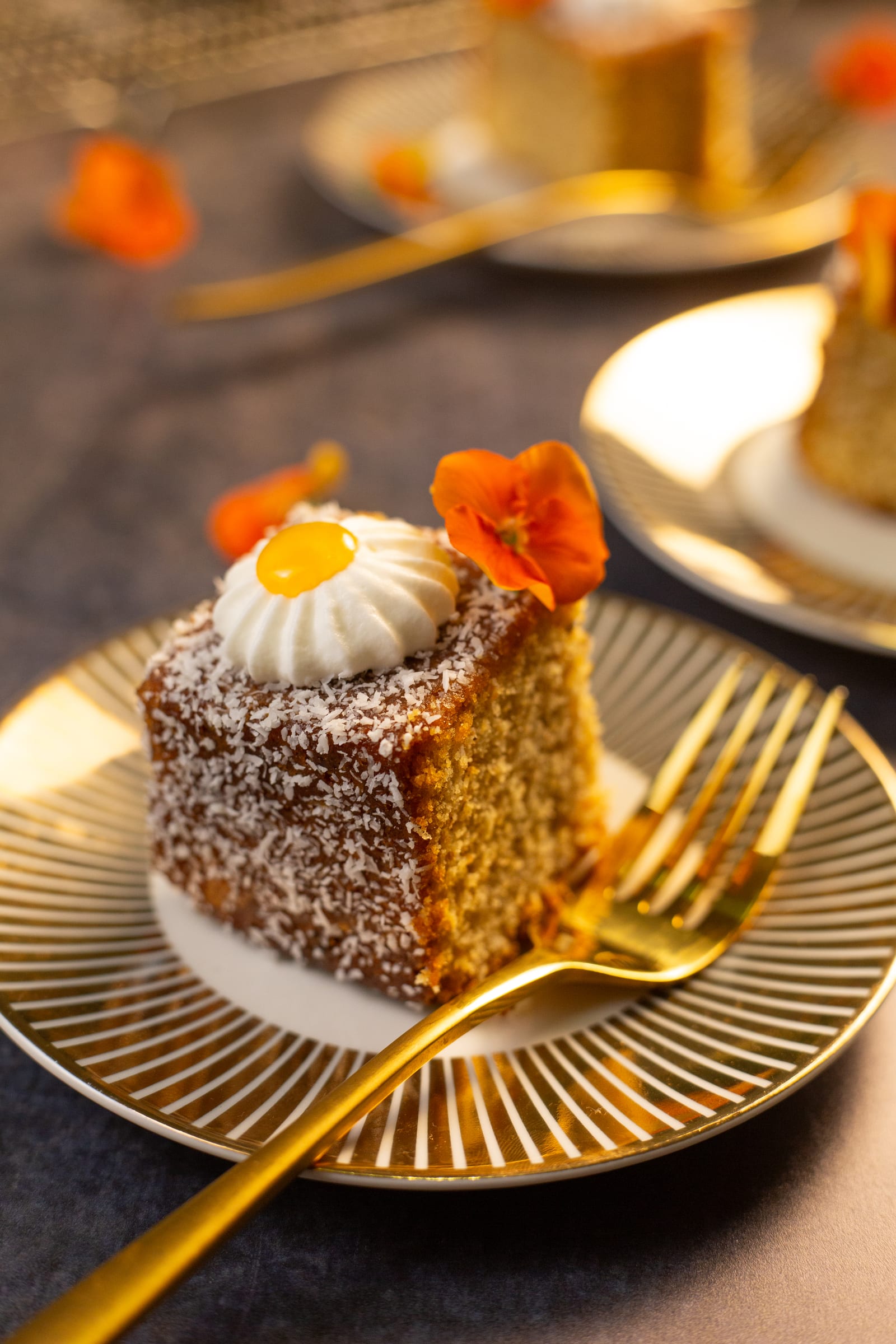 A square of traybake coated in coconut, with a gold fork