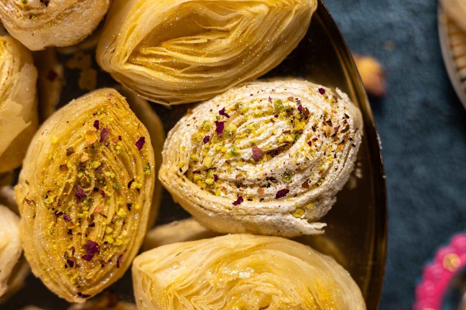A sugar-dusted banana puri among plain coils, from above