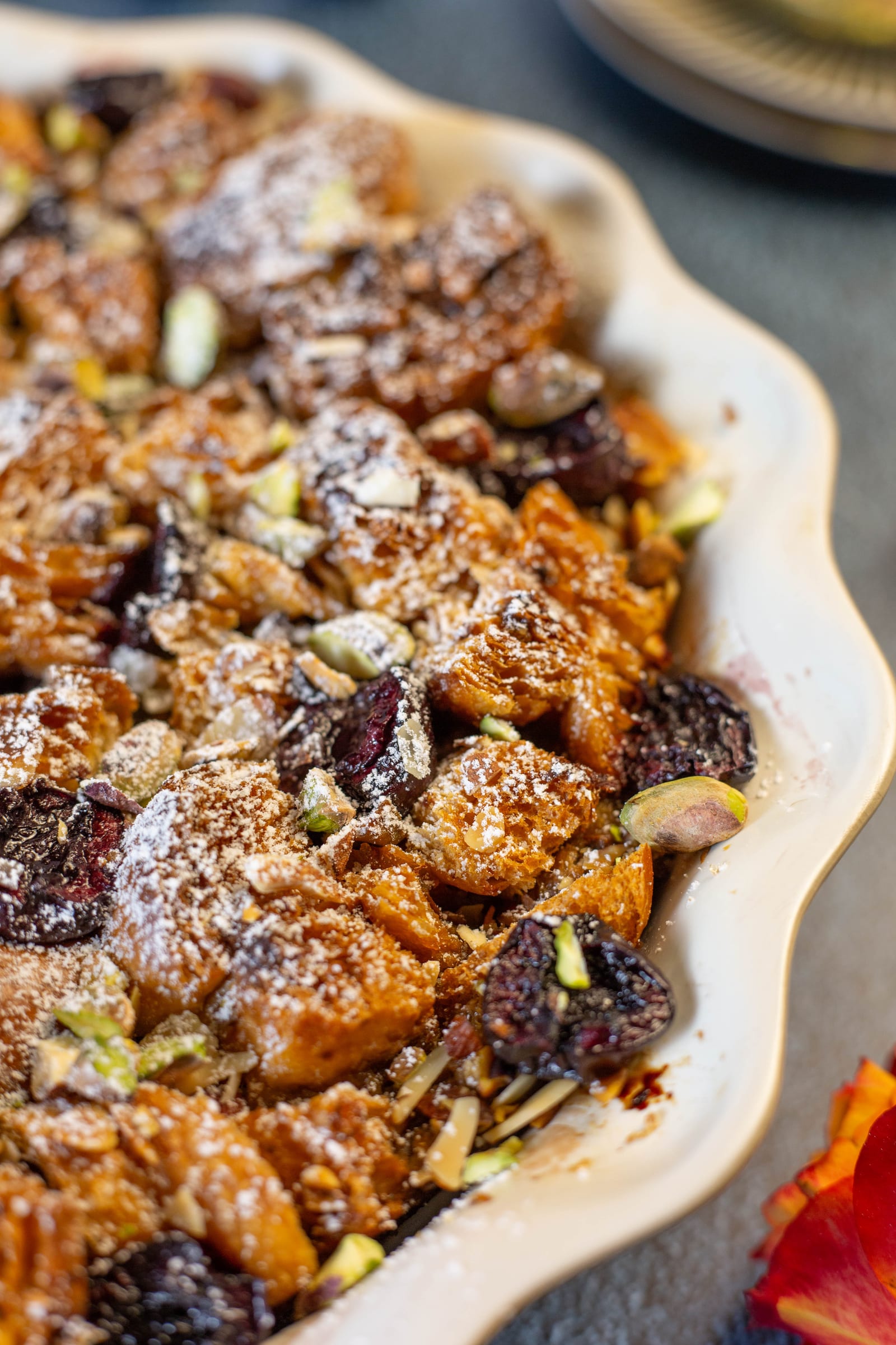 The baked pudding scattered with pistachios and cherries