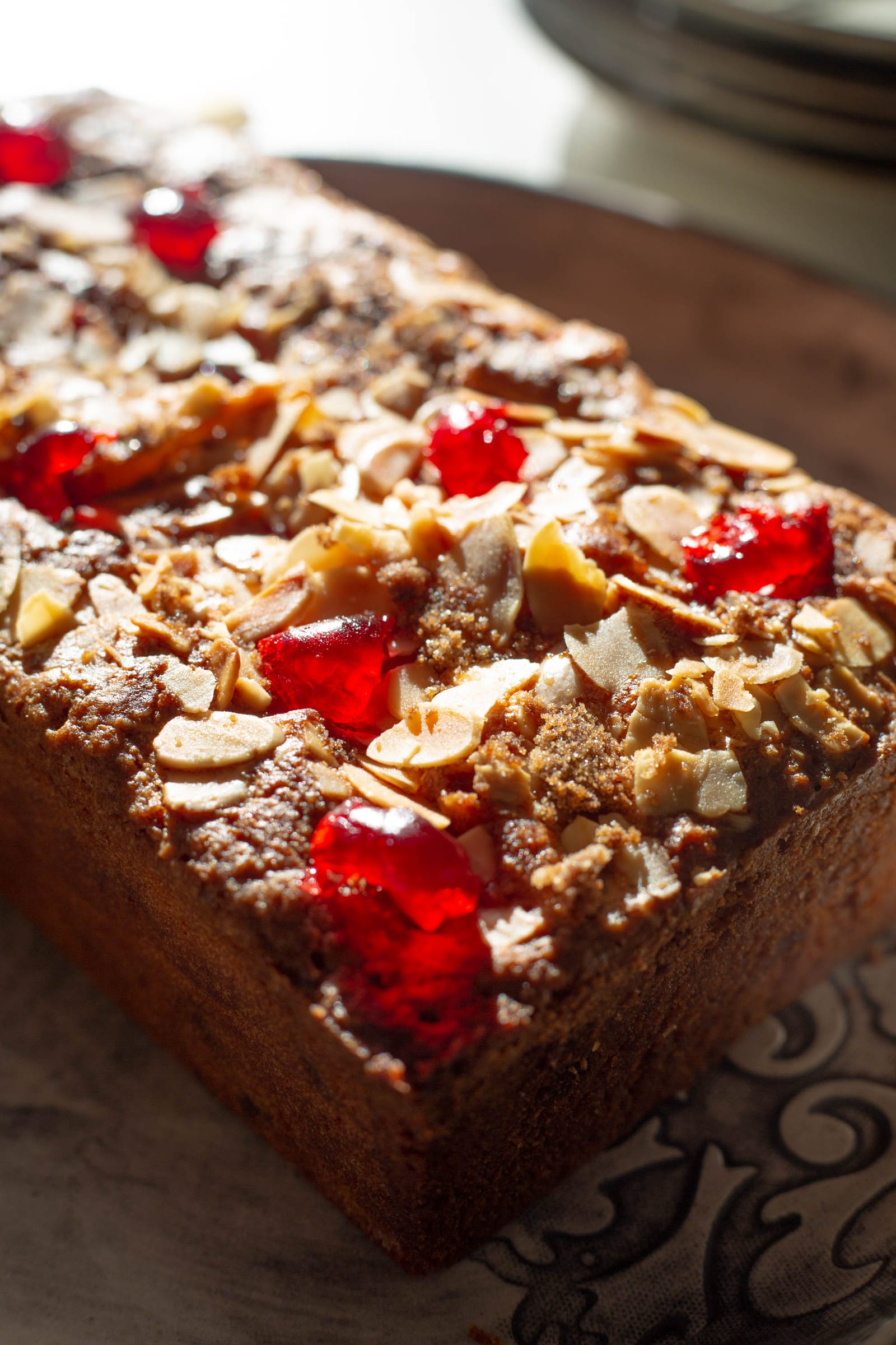 The almond-topped end of a gluten-free cherry and almond loaf