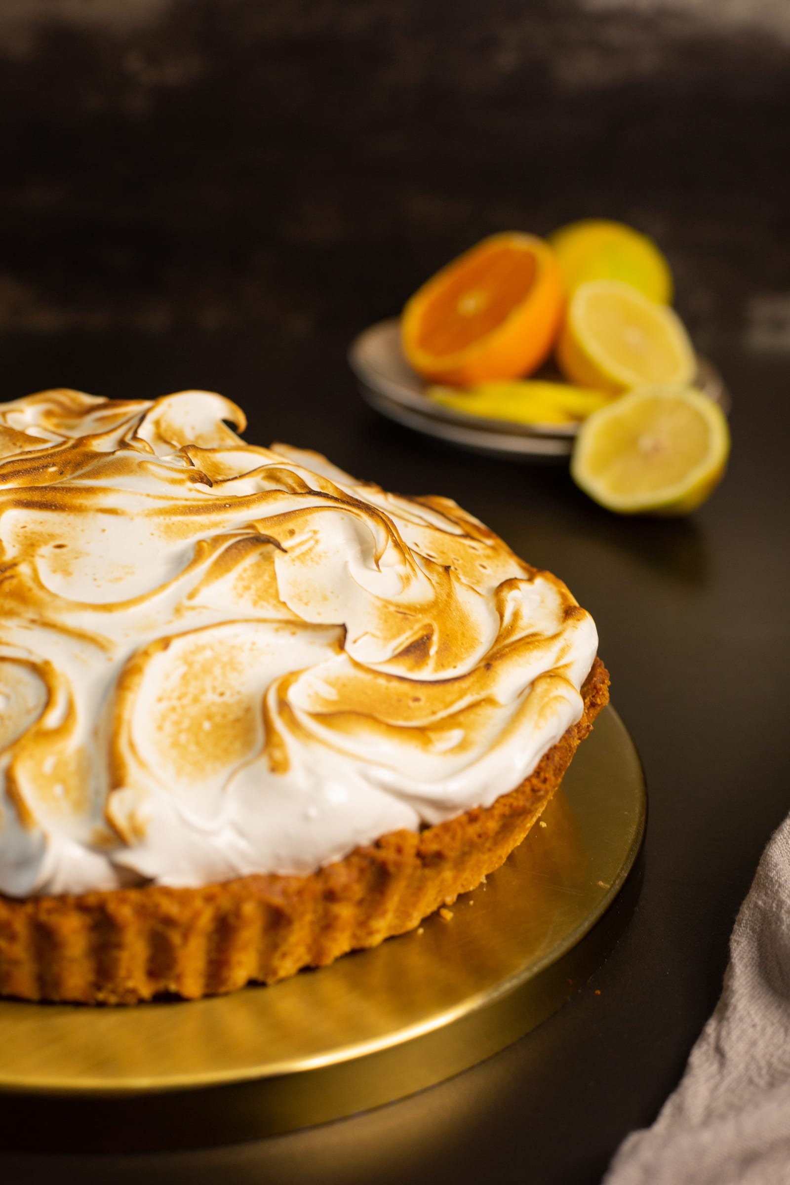 The toasted meringue piled high on the lemon meringue pie, from the side