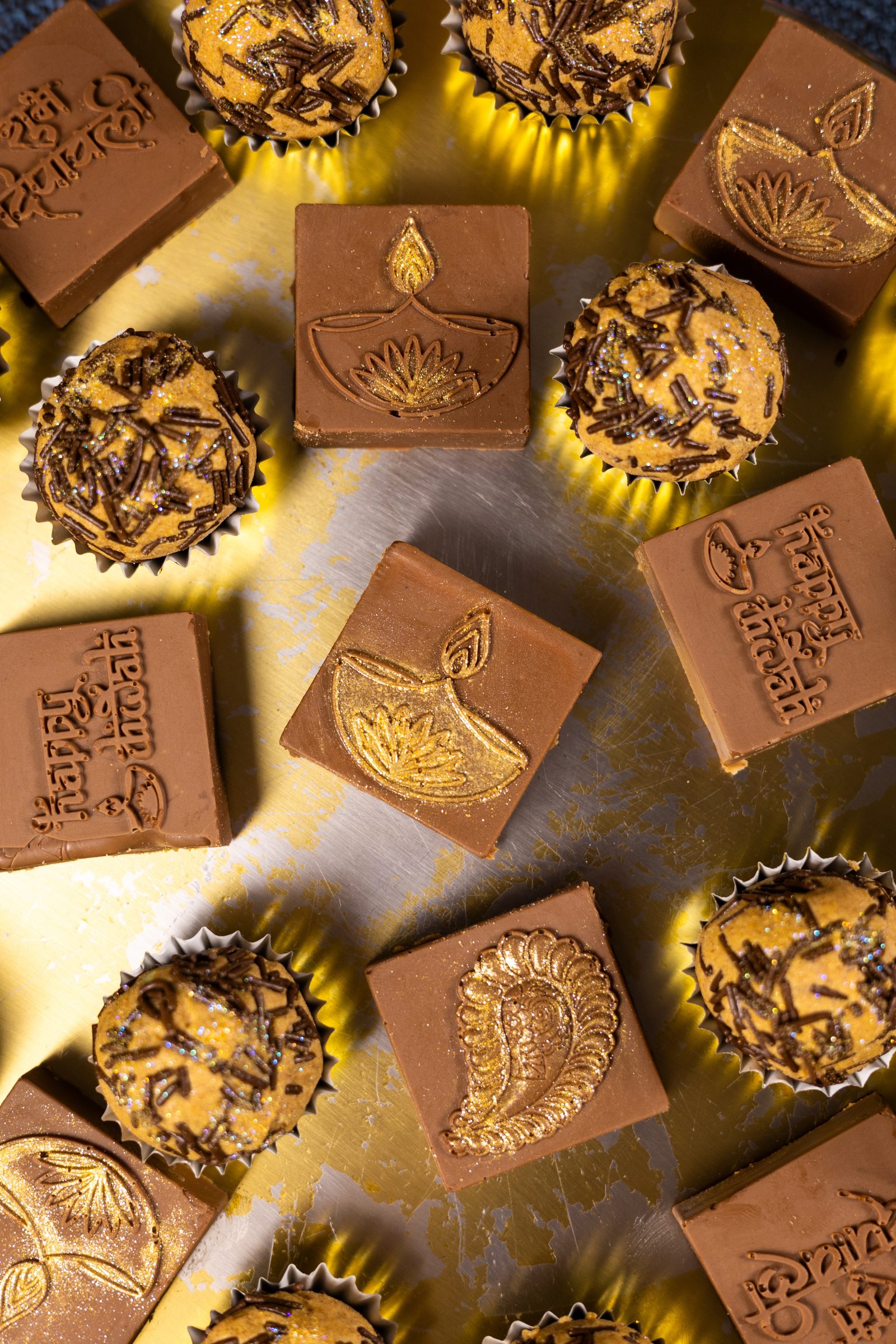 Close-up of caramel and chocolate Simply Wonderfuls from above, showing the gold diya and paisley motifs