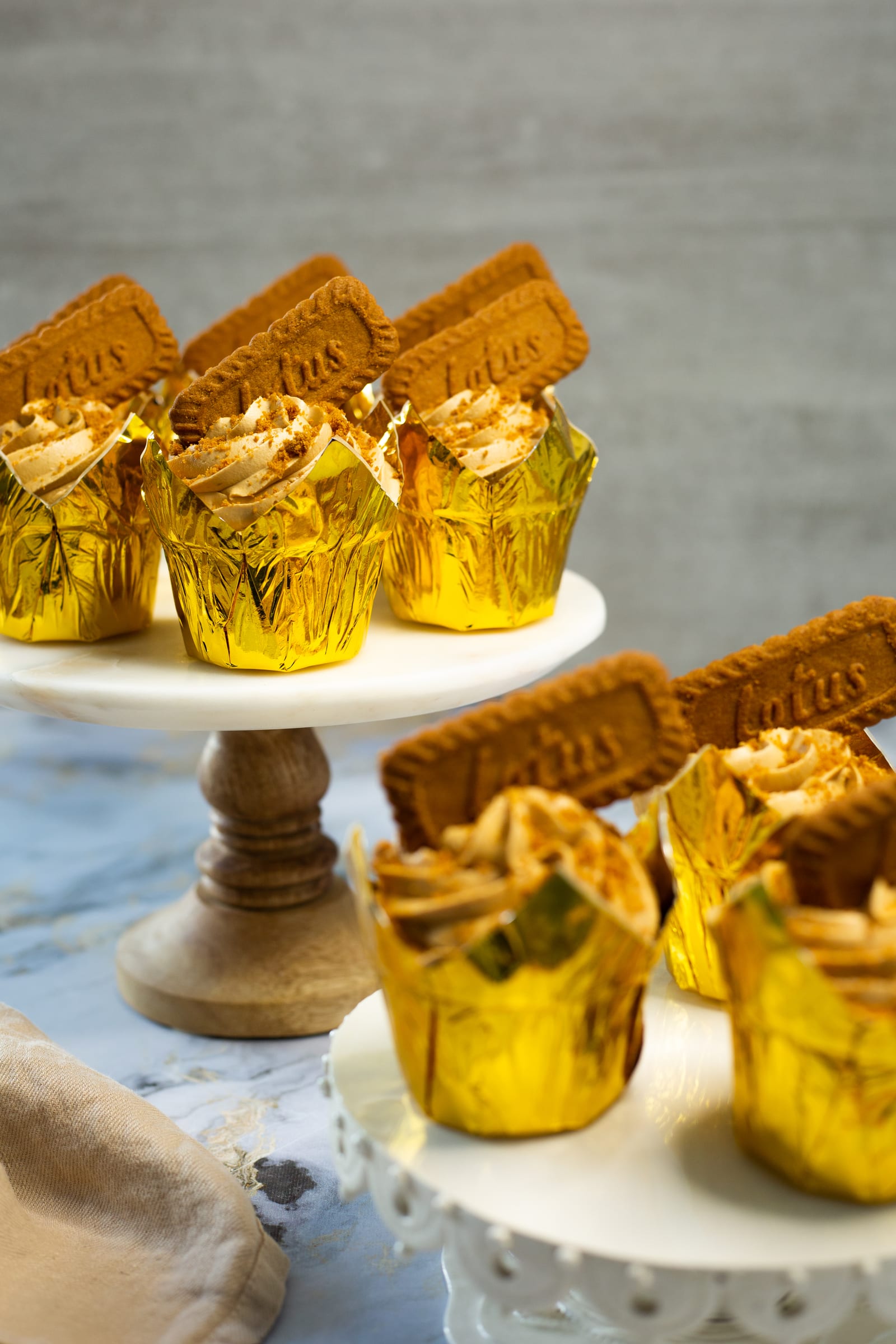 Biscoff cupcakes on two tiers of cake stands