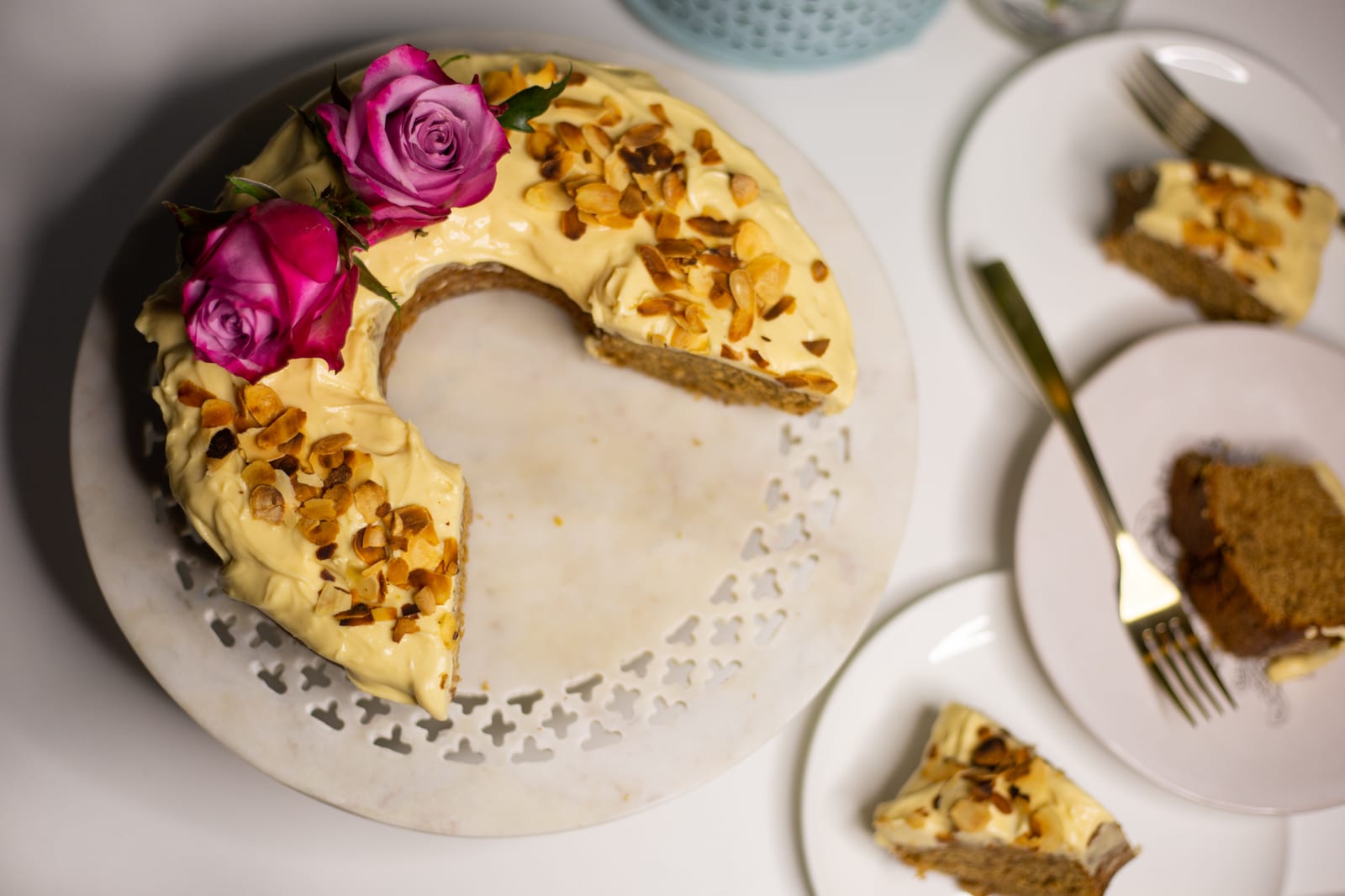A citrus pound cake with brown sugar cream cheese icing, wedges cut and slices on plates with forks, from above