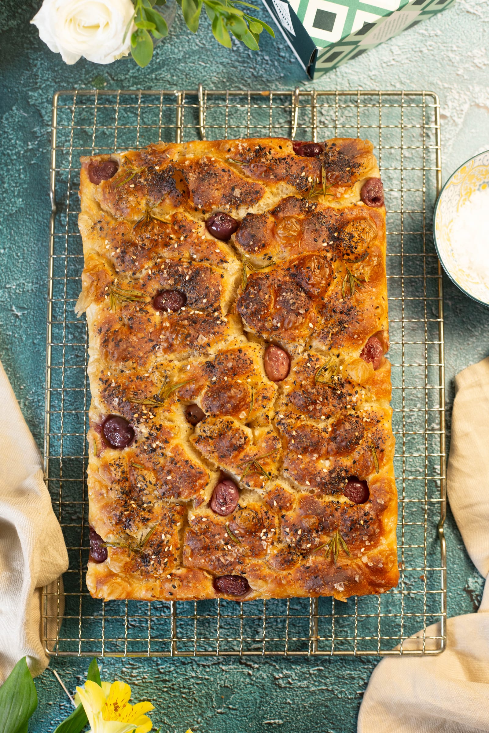A rosemary and sea salt focaccia on a wire rack, from above