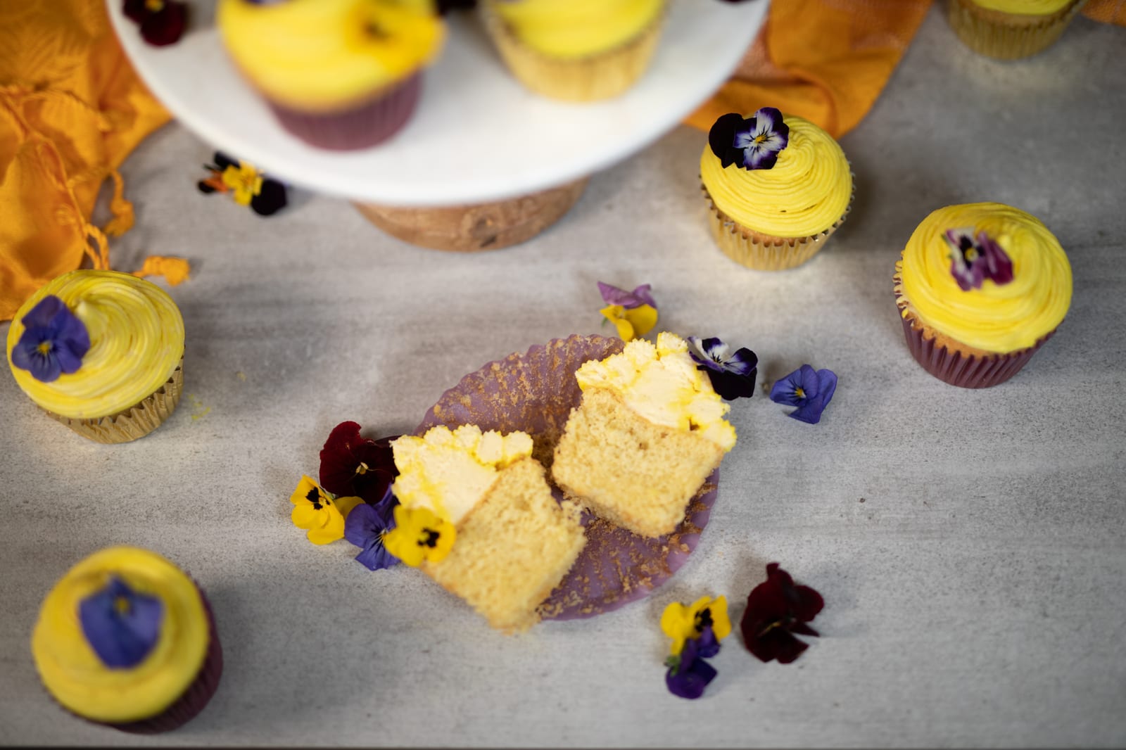 Vanilla cupcakes cut open to show their soft crumb, from above