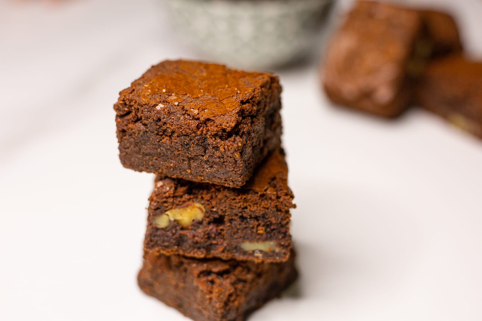 A stack of three chocolate brownies on white