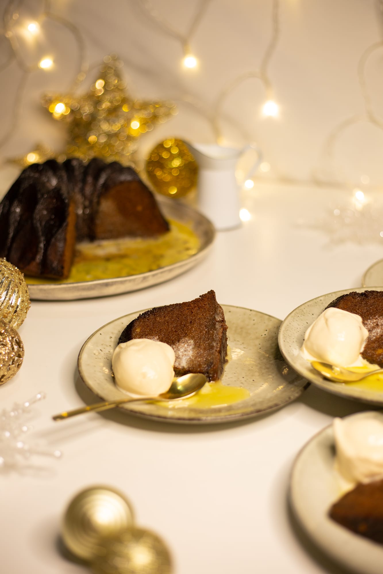 A slice of pudding with ice cream in front of the bundt