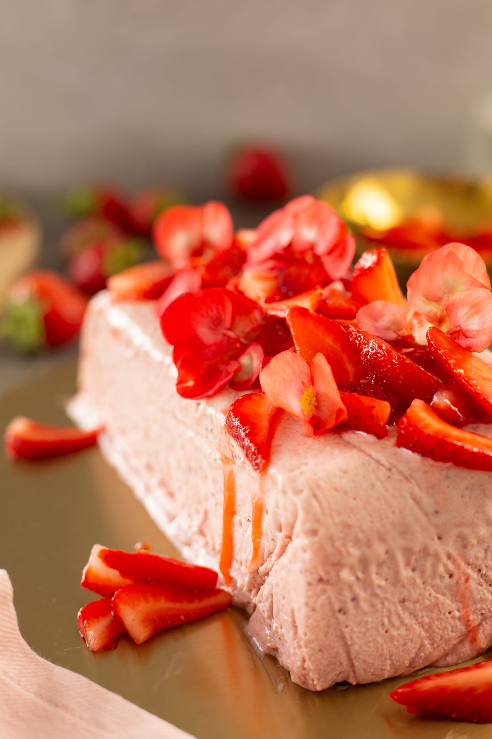 The end of a roasted strawberry and rosemary semifreddo piled high with roasted strawberries