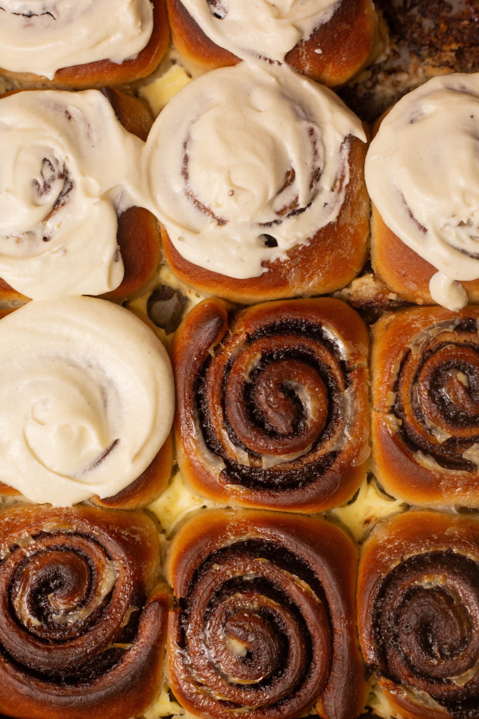 Iced and un-iced cinnamon rolls side by side