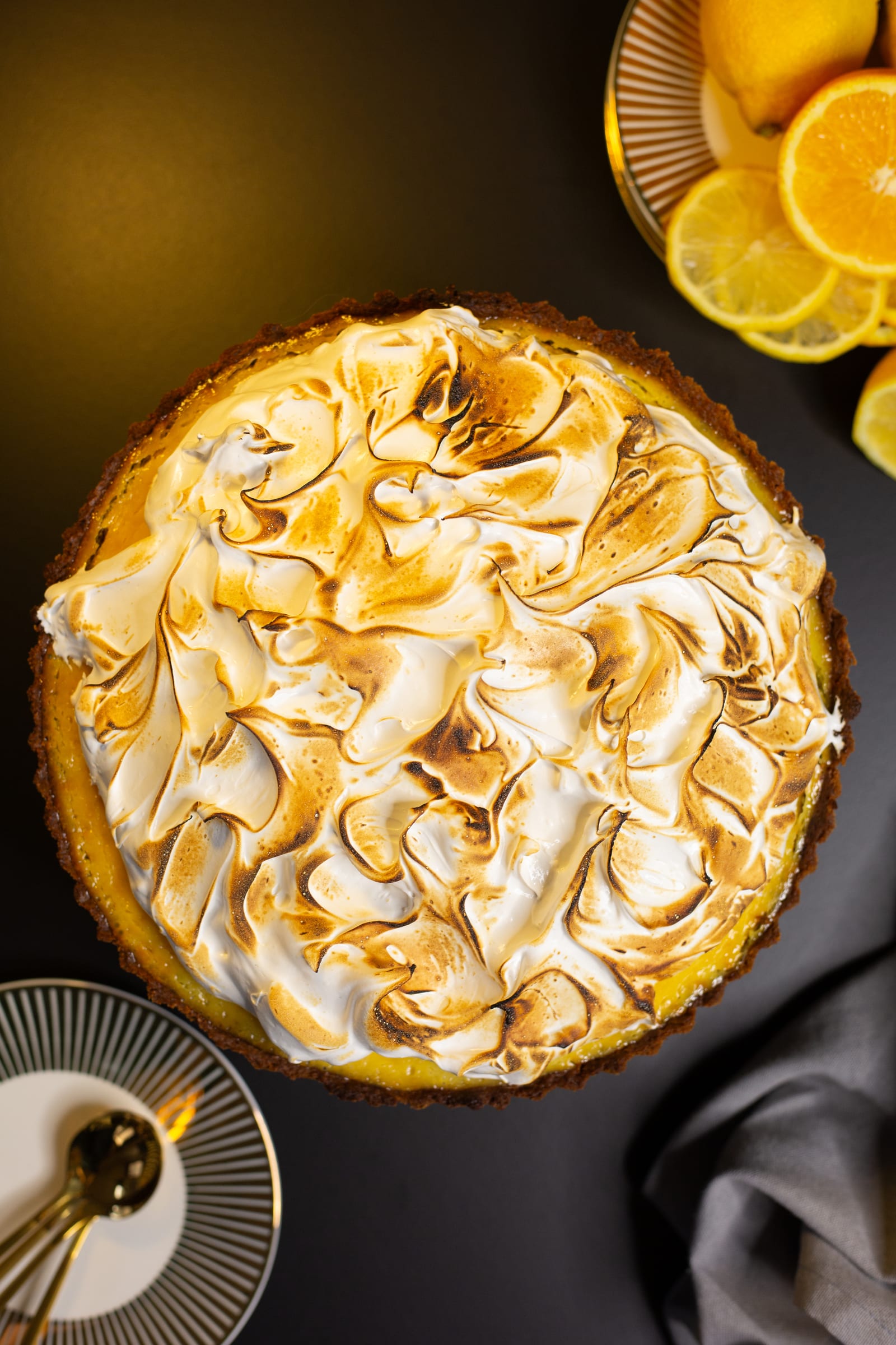 The lemon meringue pie from above, its meringue toasted in swirls