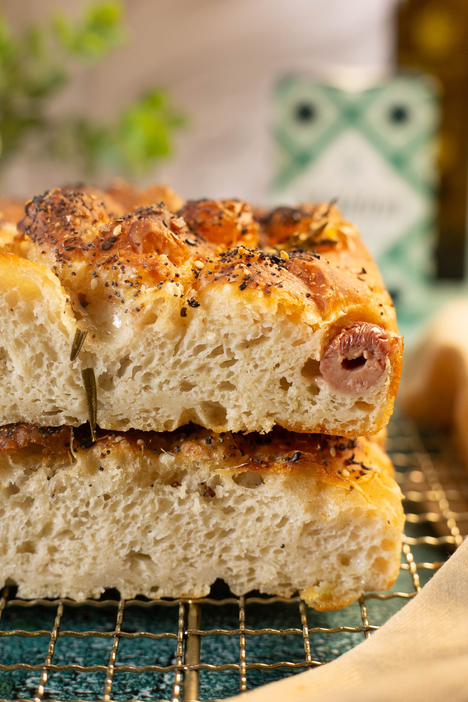 Stacked pieces of focaccia showing the airy crumb