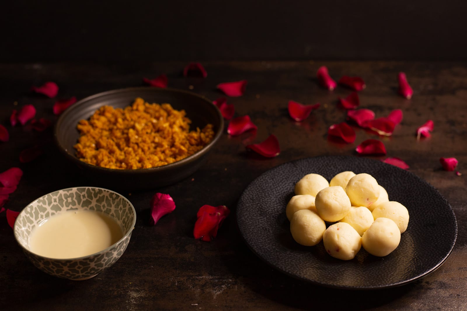 Melted white chocolate, cornflake crunch and plain truffle centres laid out among rose petals