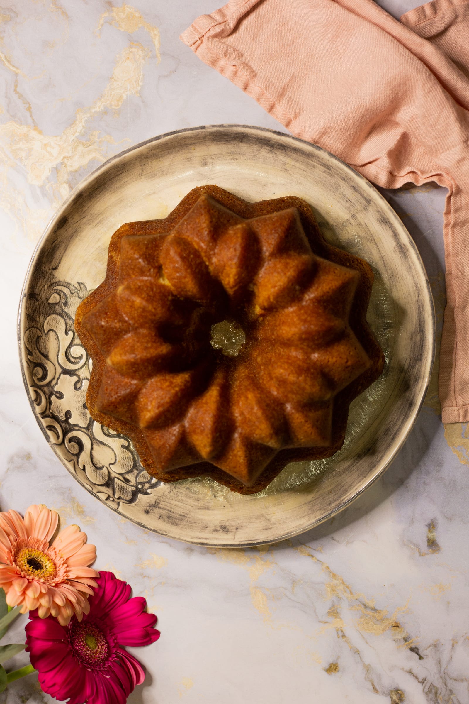 A whole Kentucky butter cake from above, its fluted bundt shape glossy with butter sauce