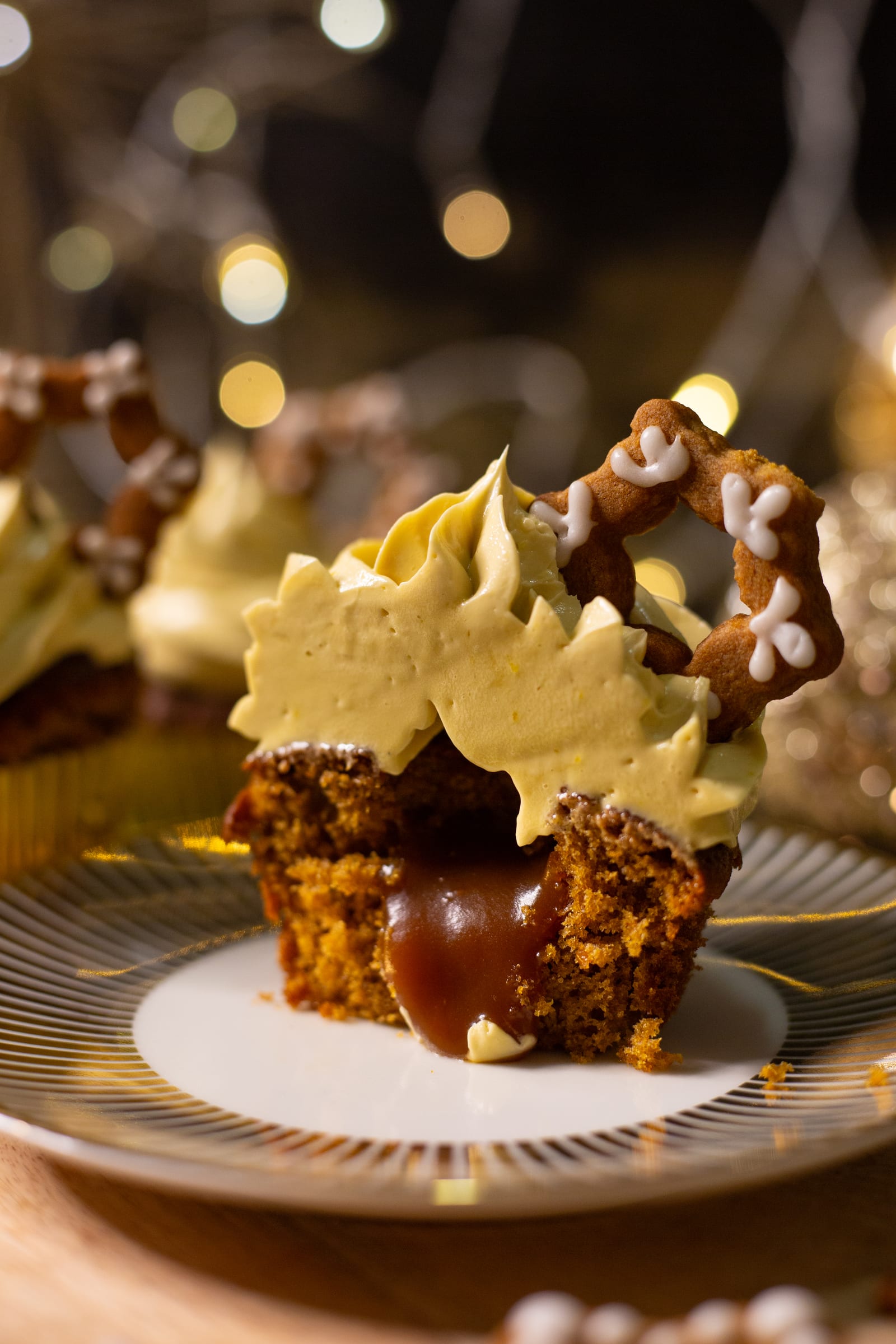 A gingerbread cupcake cut in half, showing the oozing caramel centre