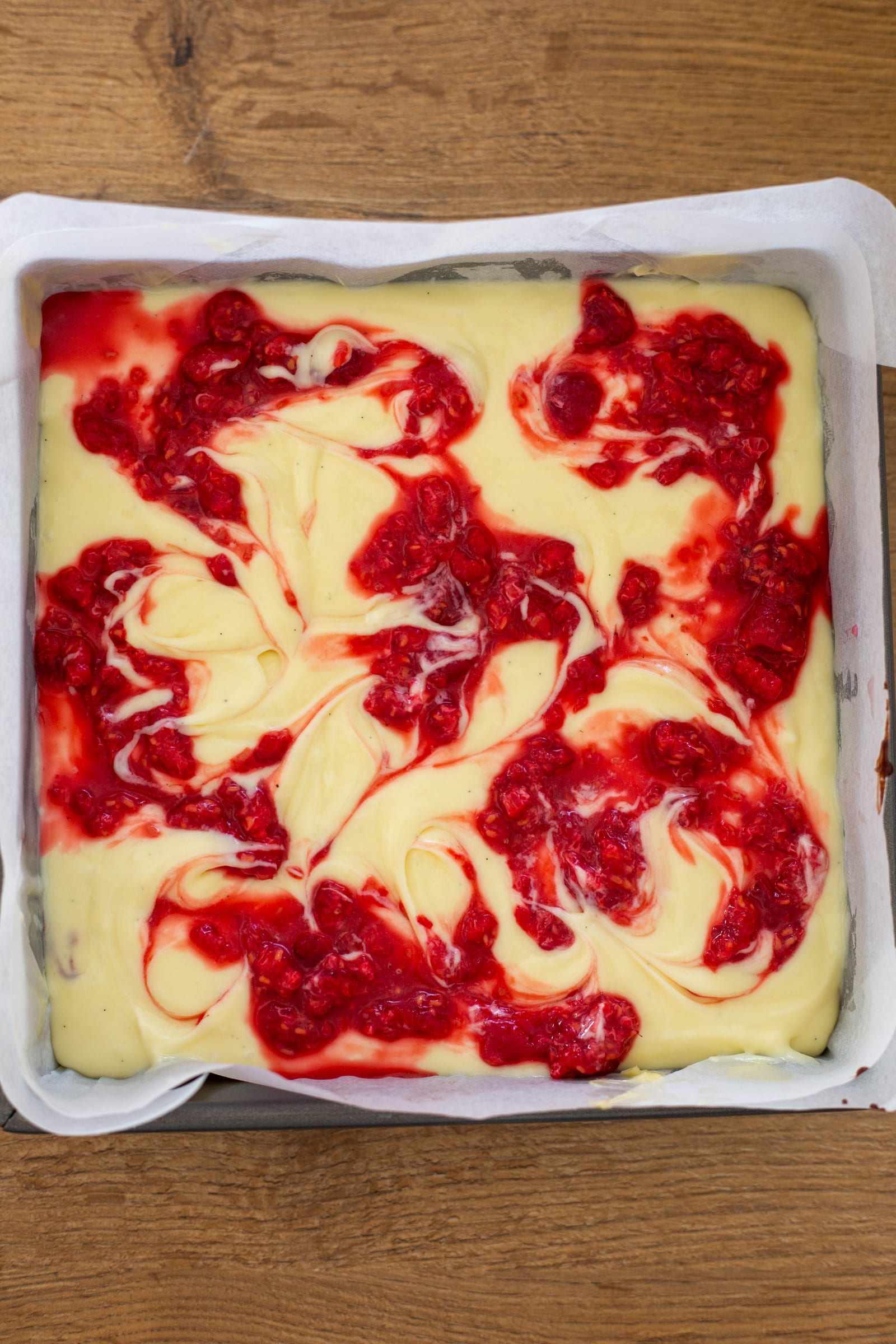Raspberry swirled through the white chocolate cheesecake layer before baking