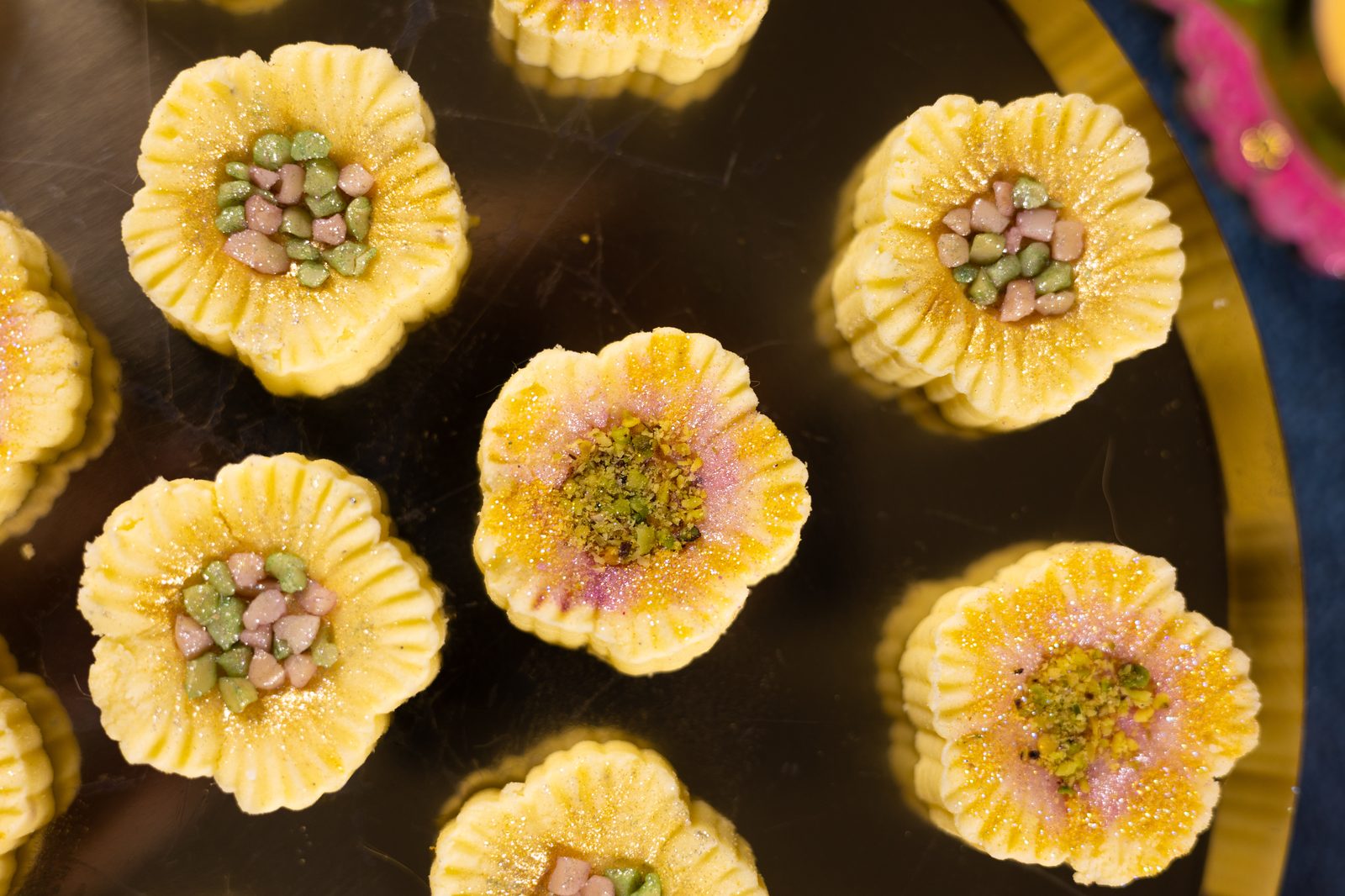 Close-up of simply wonderfuls from above, showing the pink and gold glitter and the nut centres