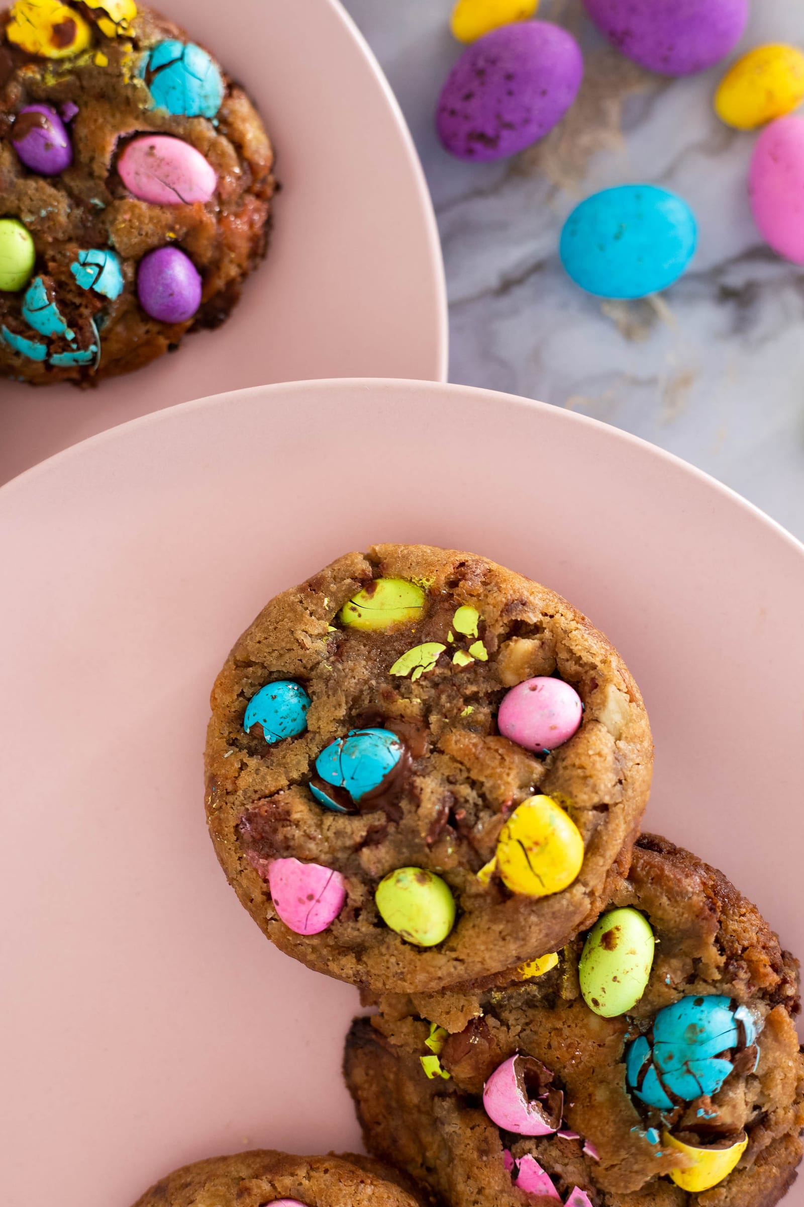 Close-up of a speckled egg choc chunk cookie on a stack, from above