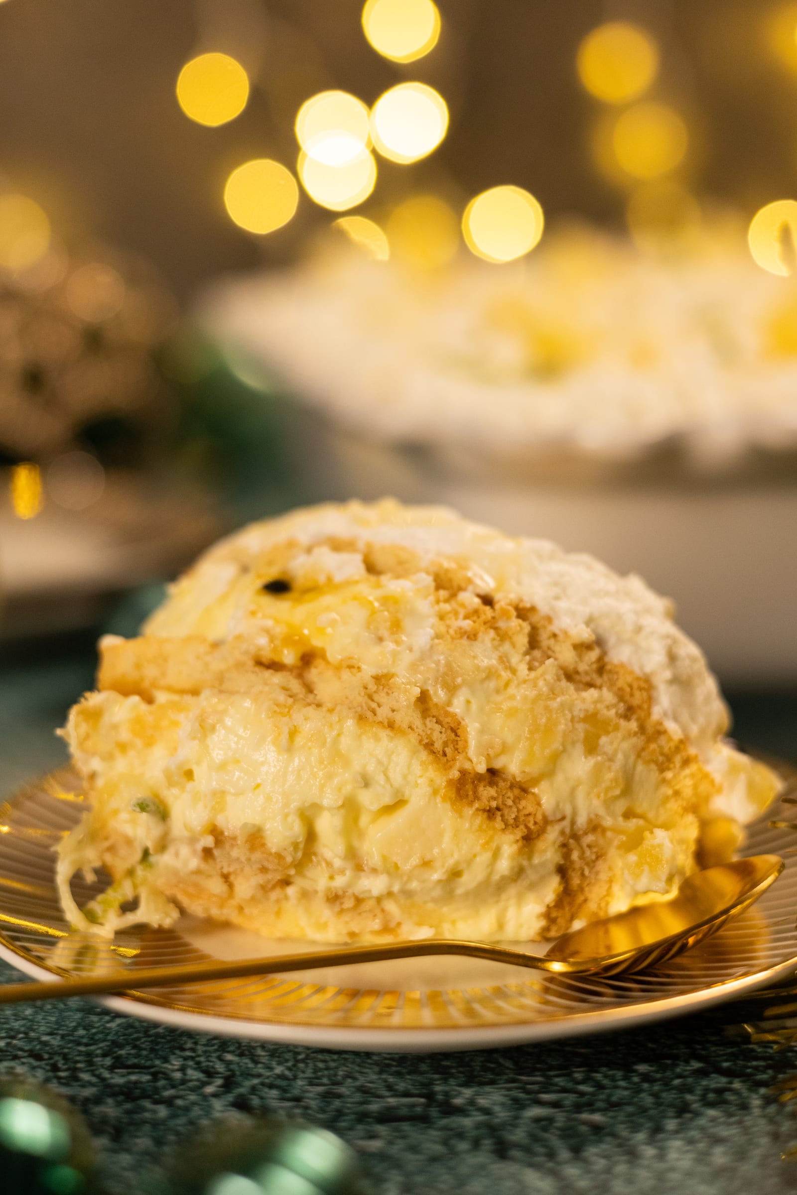 A slice of pineapple fridge tart on a gold plate