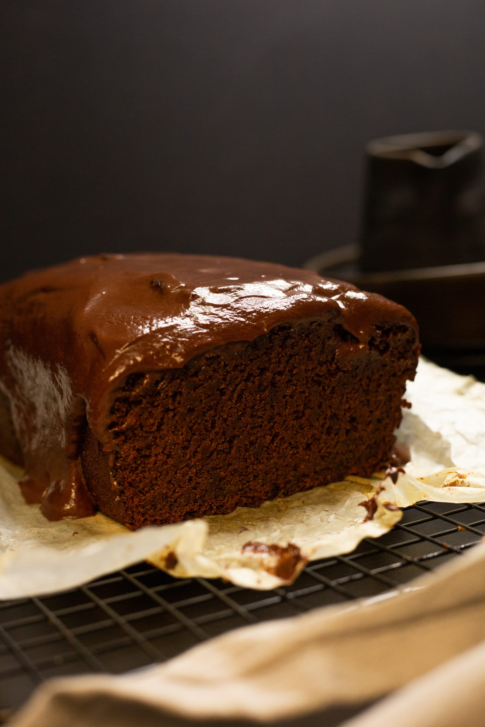 The cut end of the glazed chocolate banana bread, showing its moist crumb