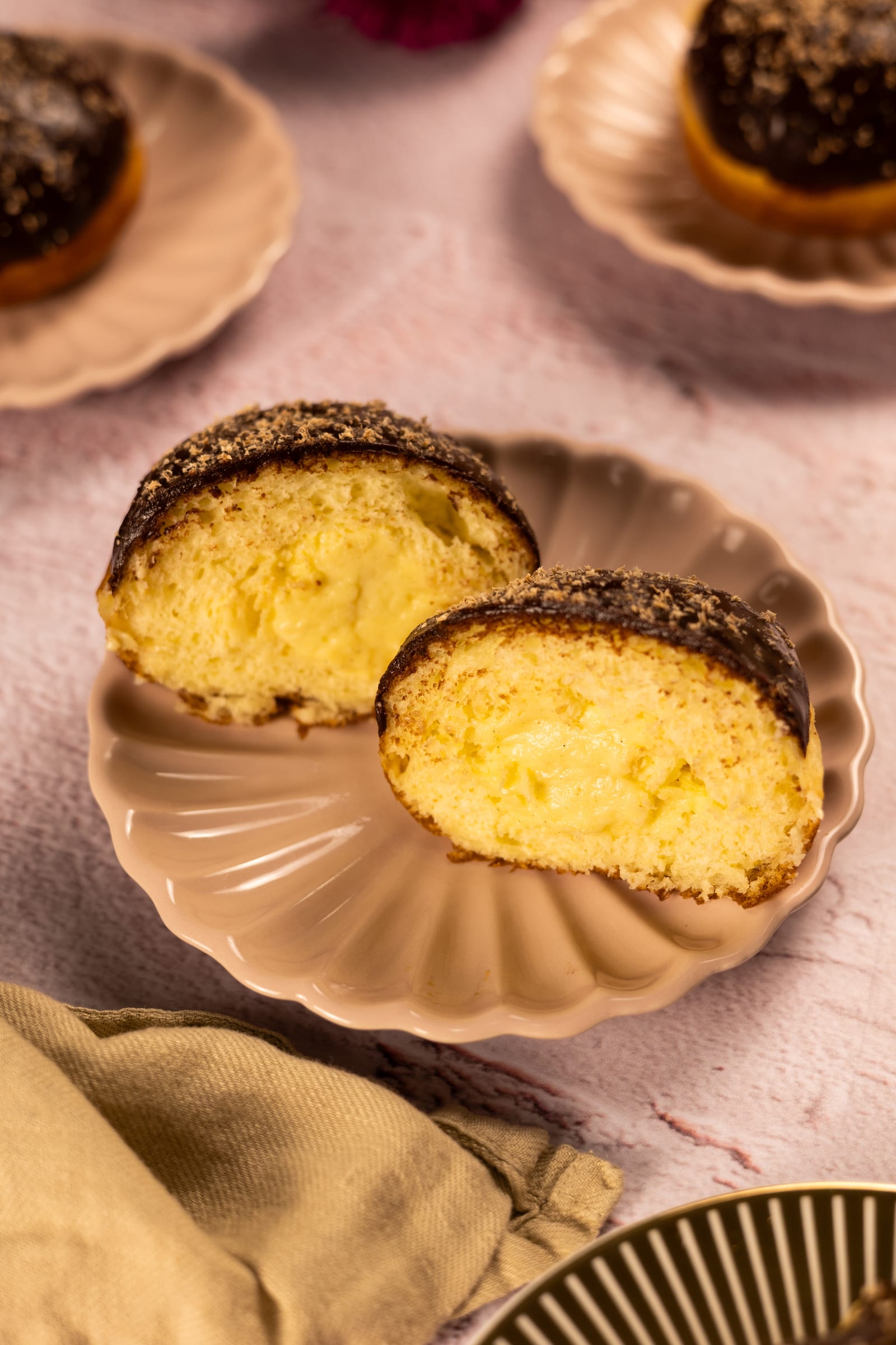 A donut cut in half to show its soft brioche and milk tart filling