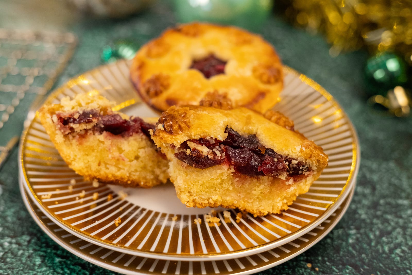 Cherry and amaretto pies broken open on a gold-rimmed plate