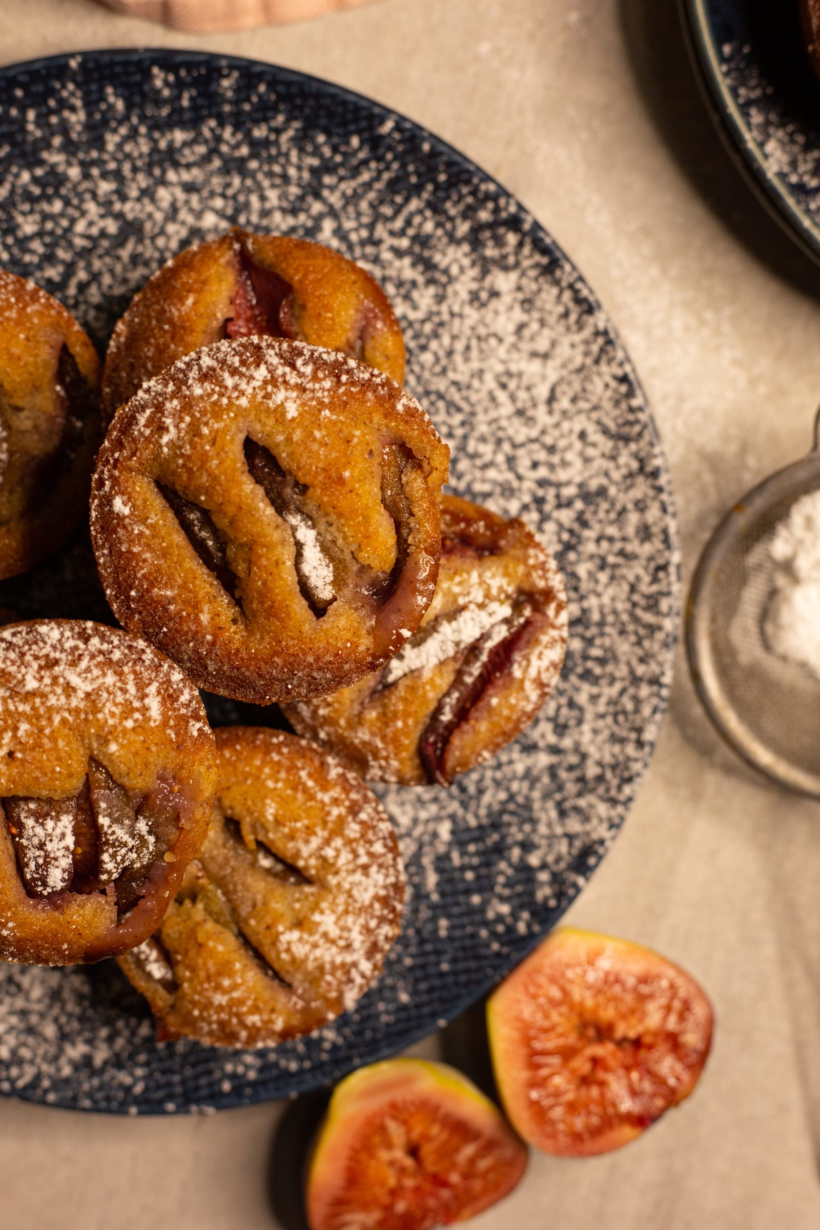 Close-up of fig and hazelnut friands dusted with icing sugar, from above