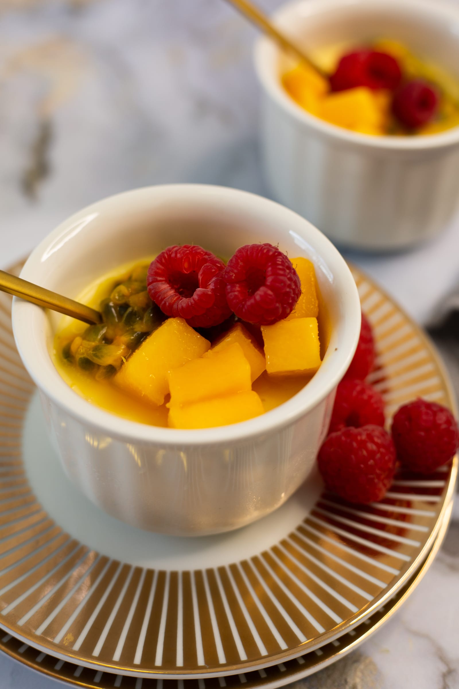 The mango, granadilla and raspberry topping on a coconut, mango and granadilla baked yogurt, close up