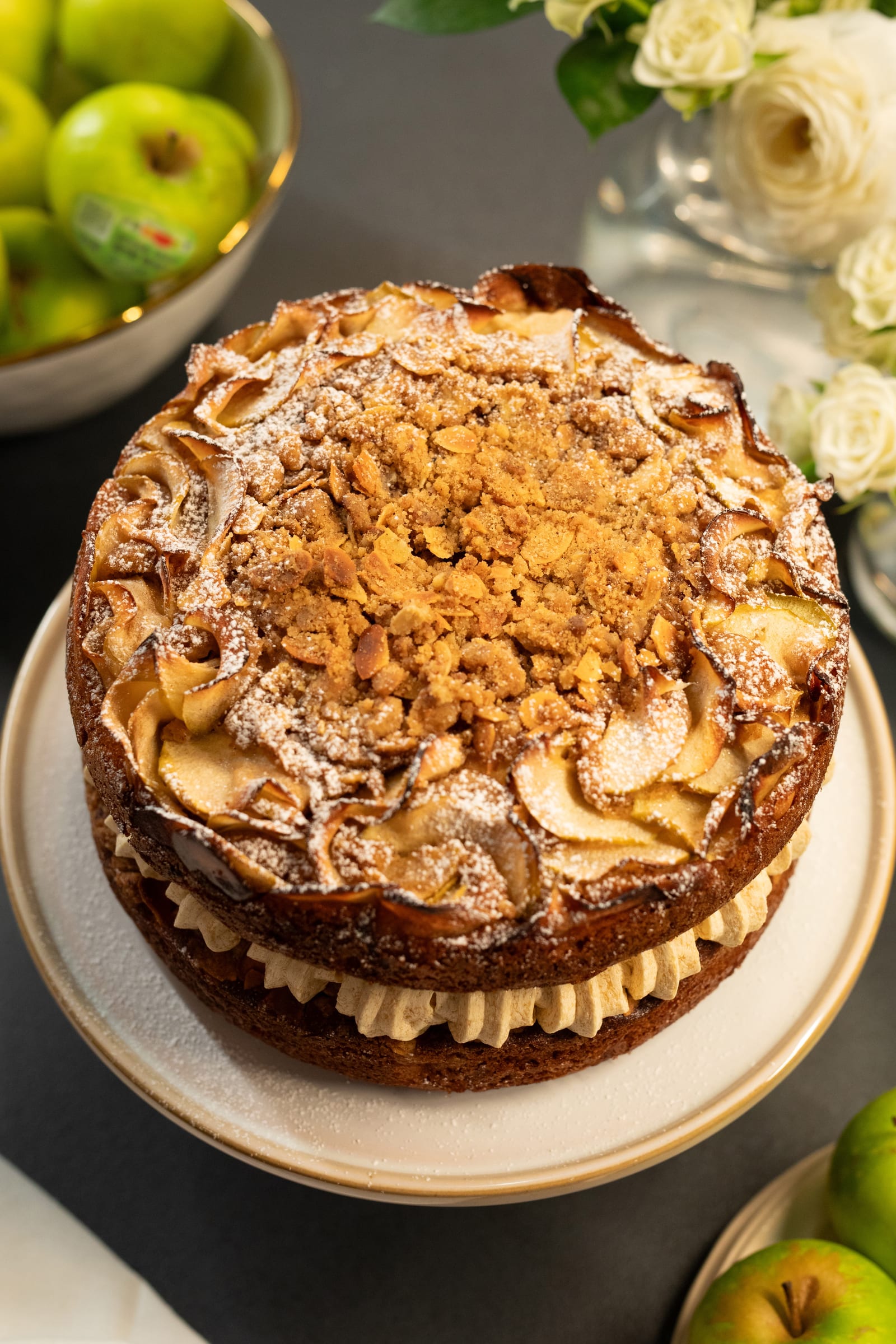 The top of the apple crumble cake with its crumble and sliced-apple lacework