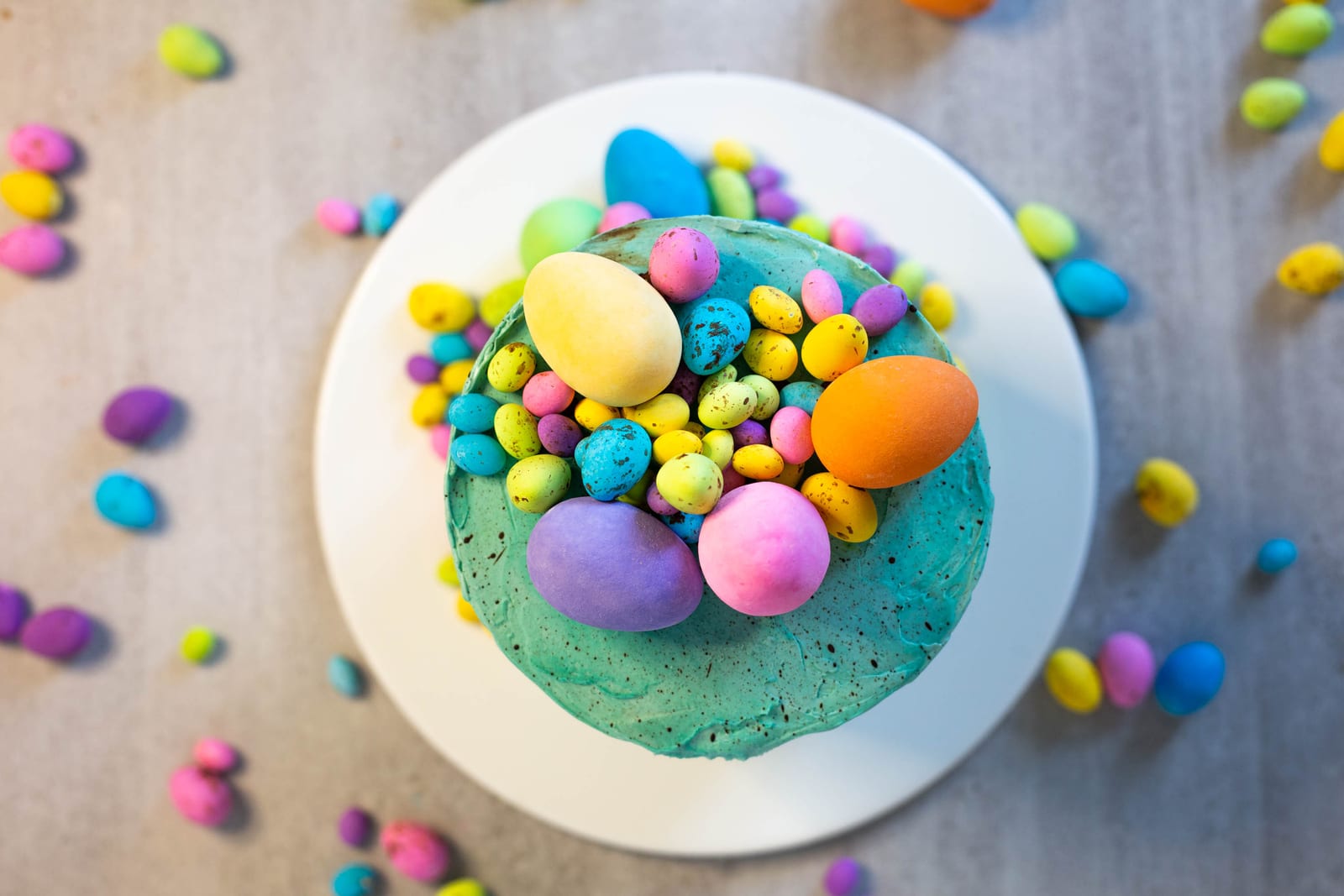 The top of a speckled egg cake piled with speckled eggs, from above