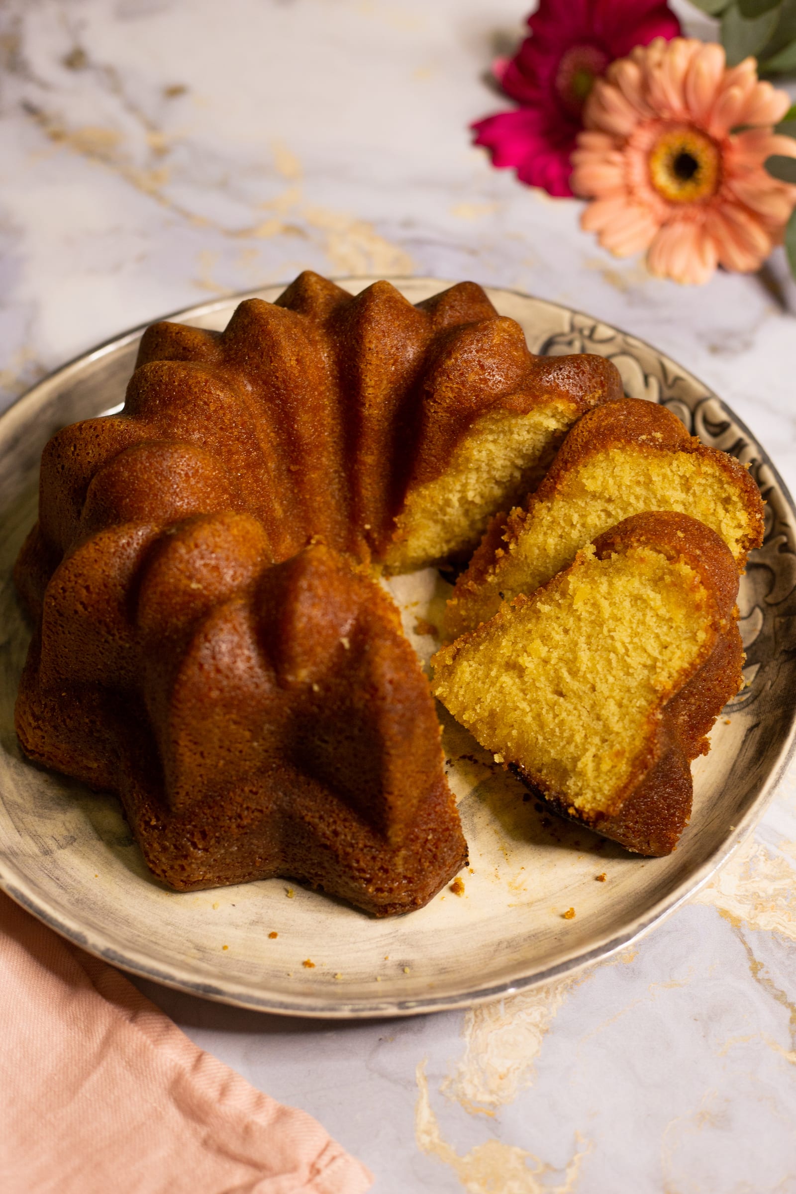 A Kentucky butter cake with slices cut away to show the golden crumb