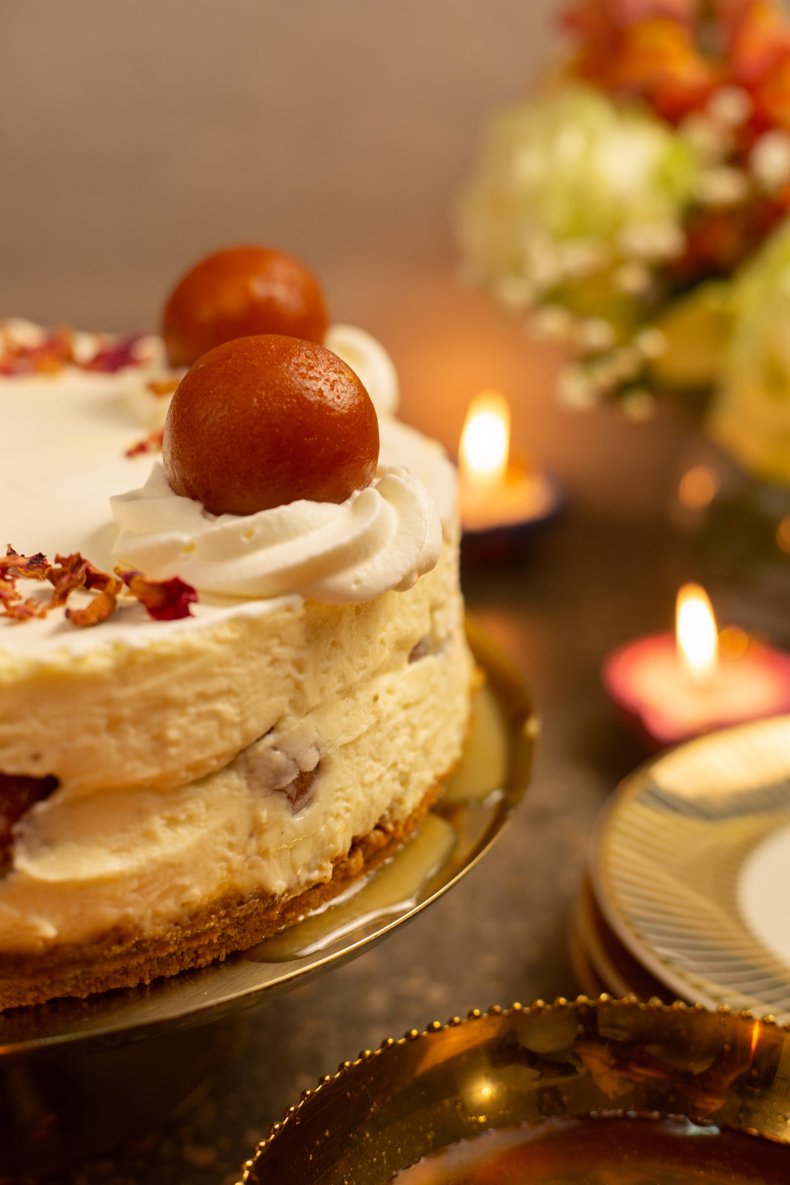 The side of the cheesecake, with candles glowing behind