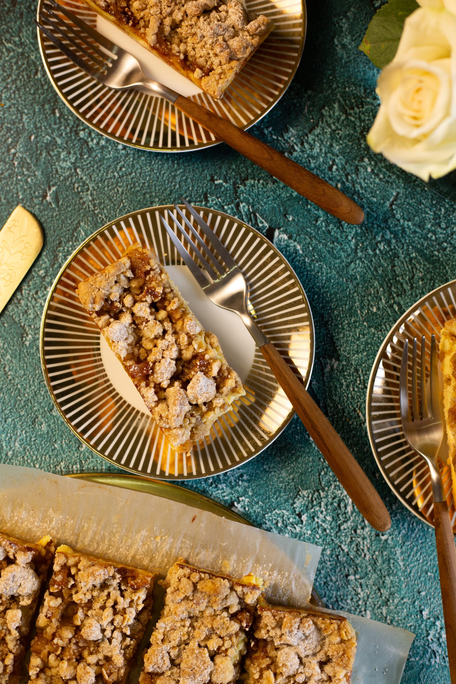 Plates of milk tart crumble bars with forks, from above