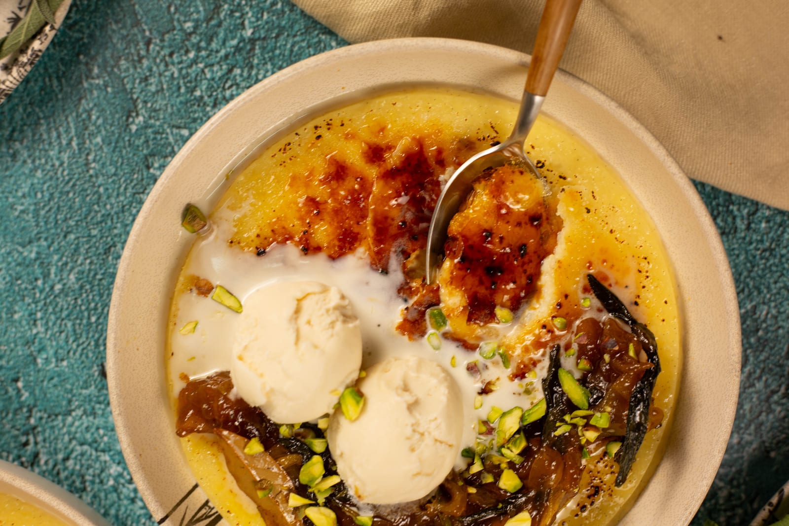 A bowl of basmati rice pudding with a brûléed top, ice cream and apples fried in sage, from above