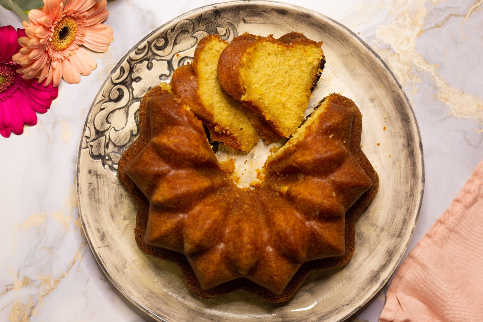 A Kentucky butter cake on a patterned plate from above, with slices cut and fanned across the top