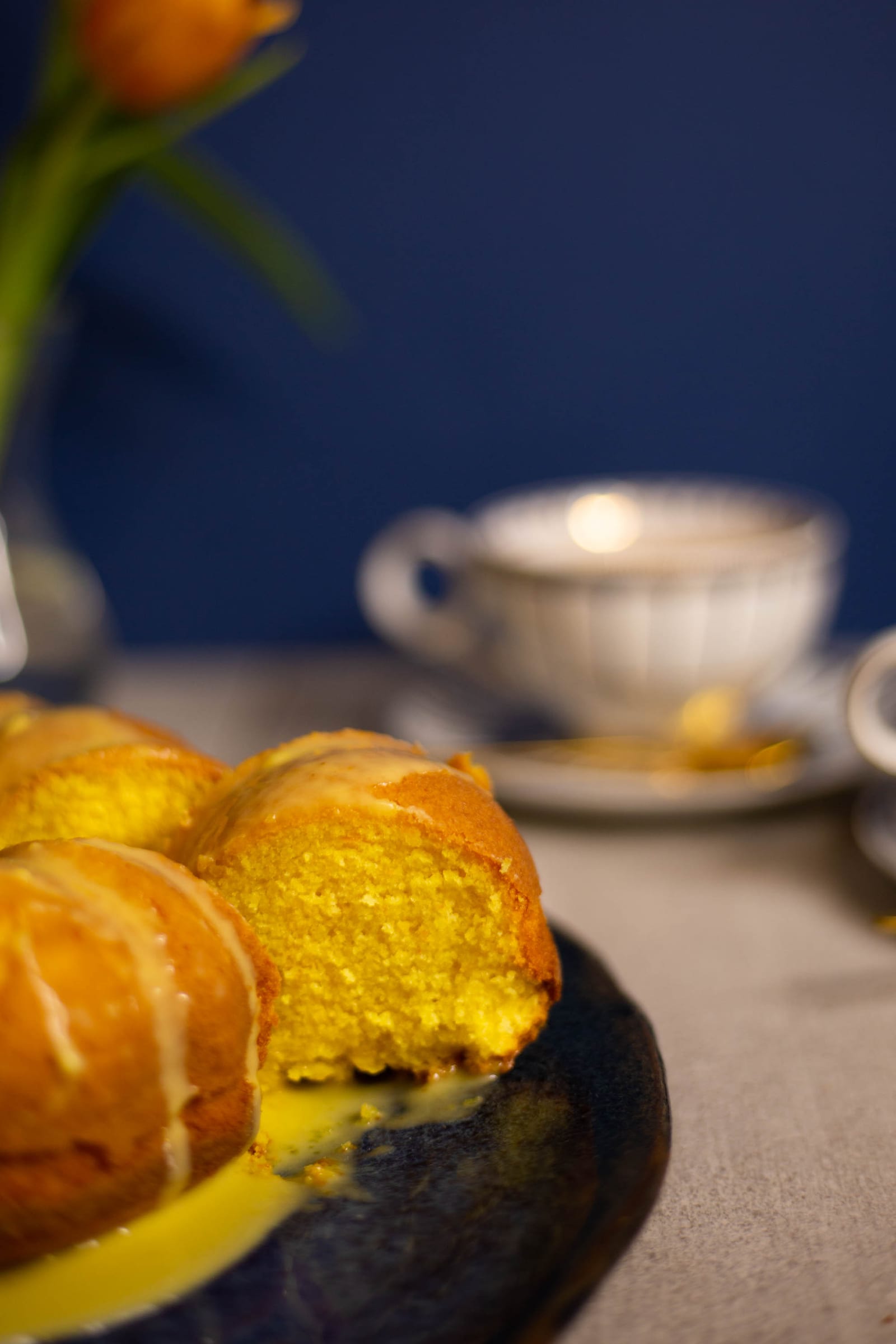 A cut saffron milk cake showing its golden crumb