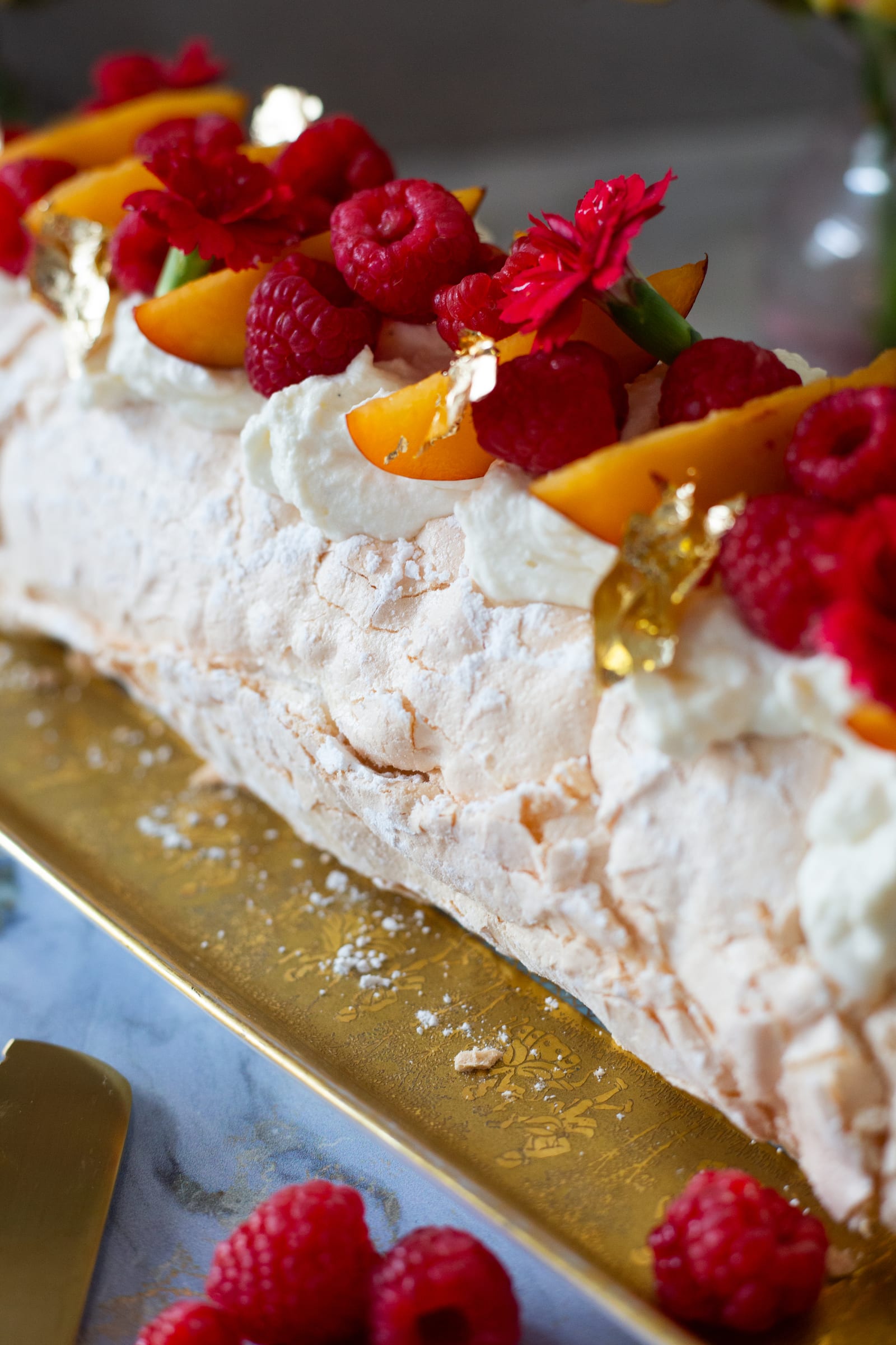 A close look at the crisp meringue crust under raspberries and nectarine slices
