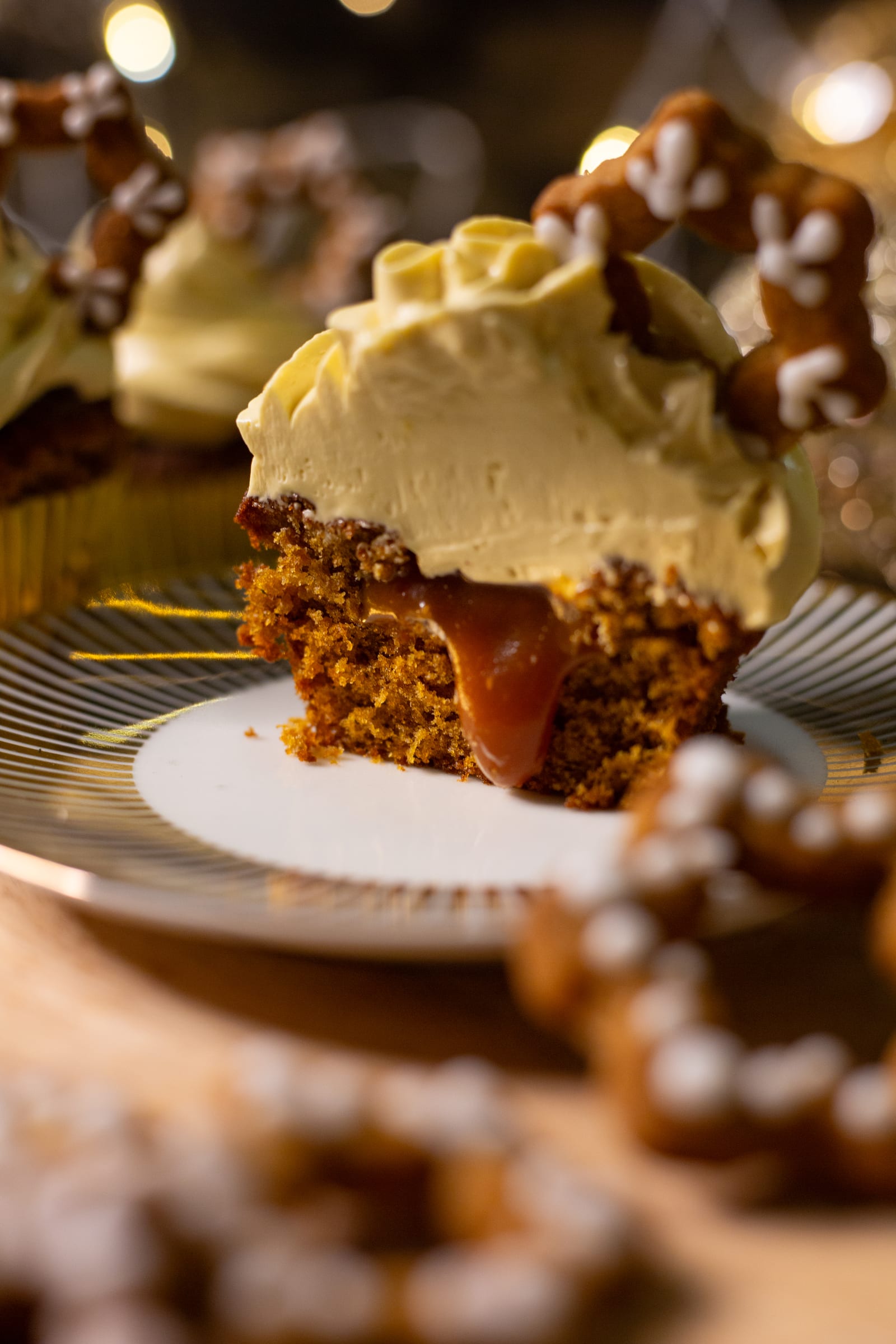 A halved gingerbread cupcake showing its soft crumb and caramel centre