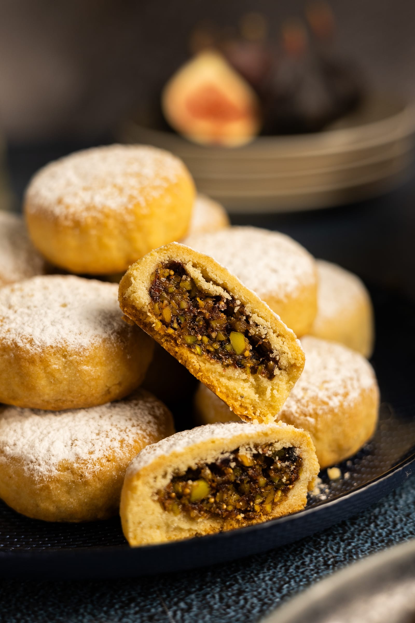 A ma'amoul broken open to show the fig and pistachio filling