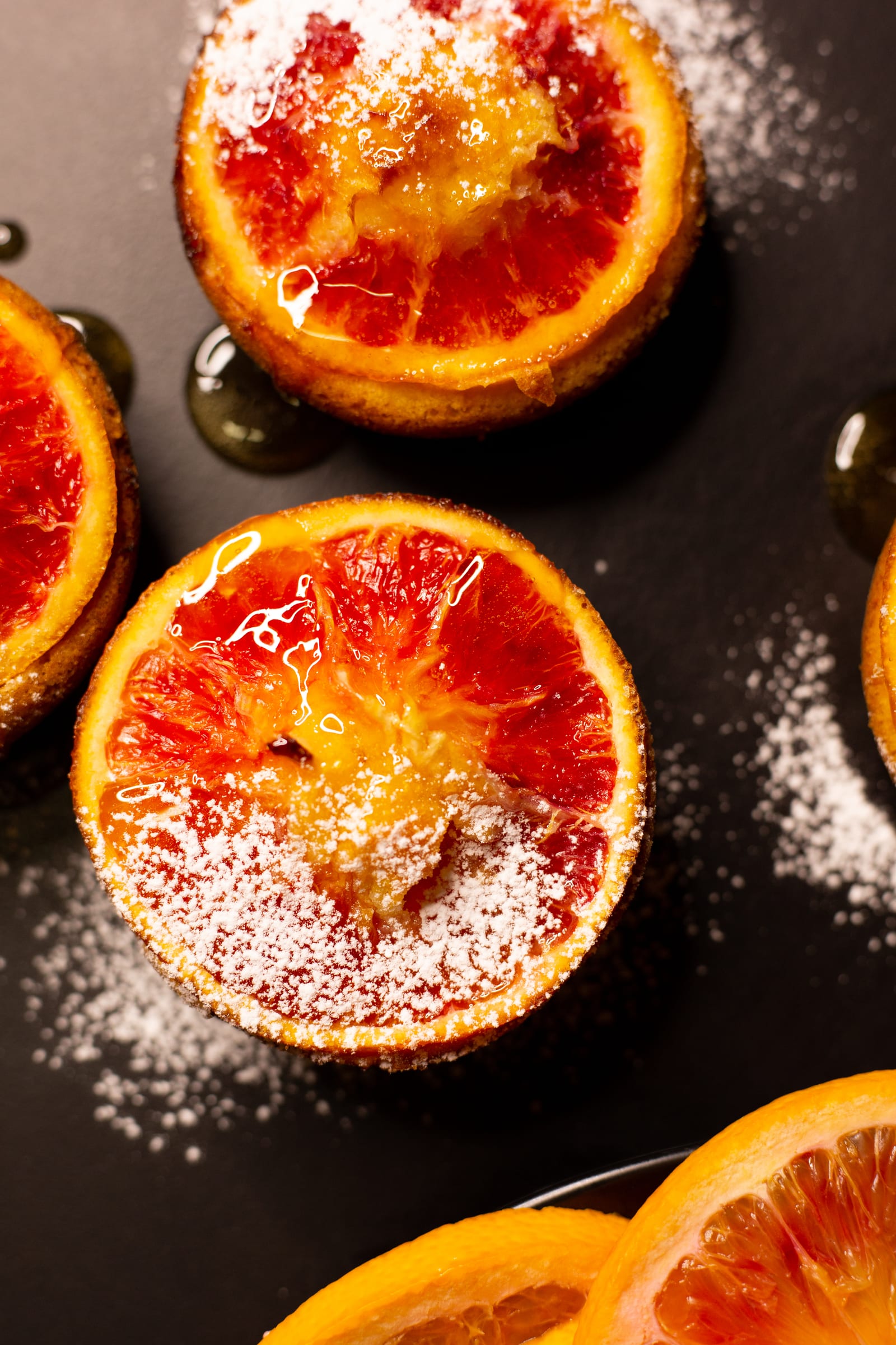 An almond, semolina and blood orange syrup cake with a blood orange slice on top, from above